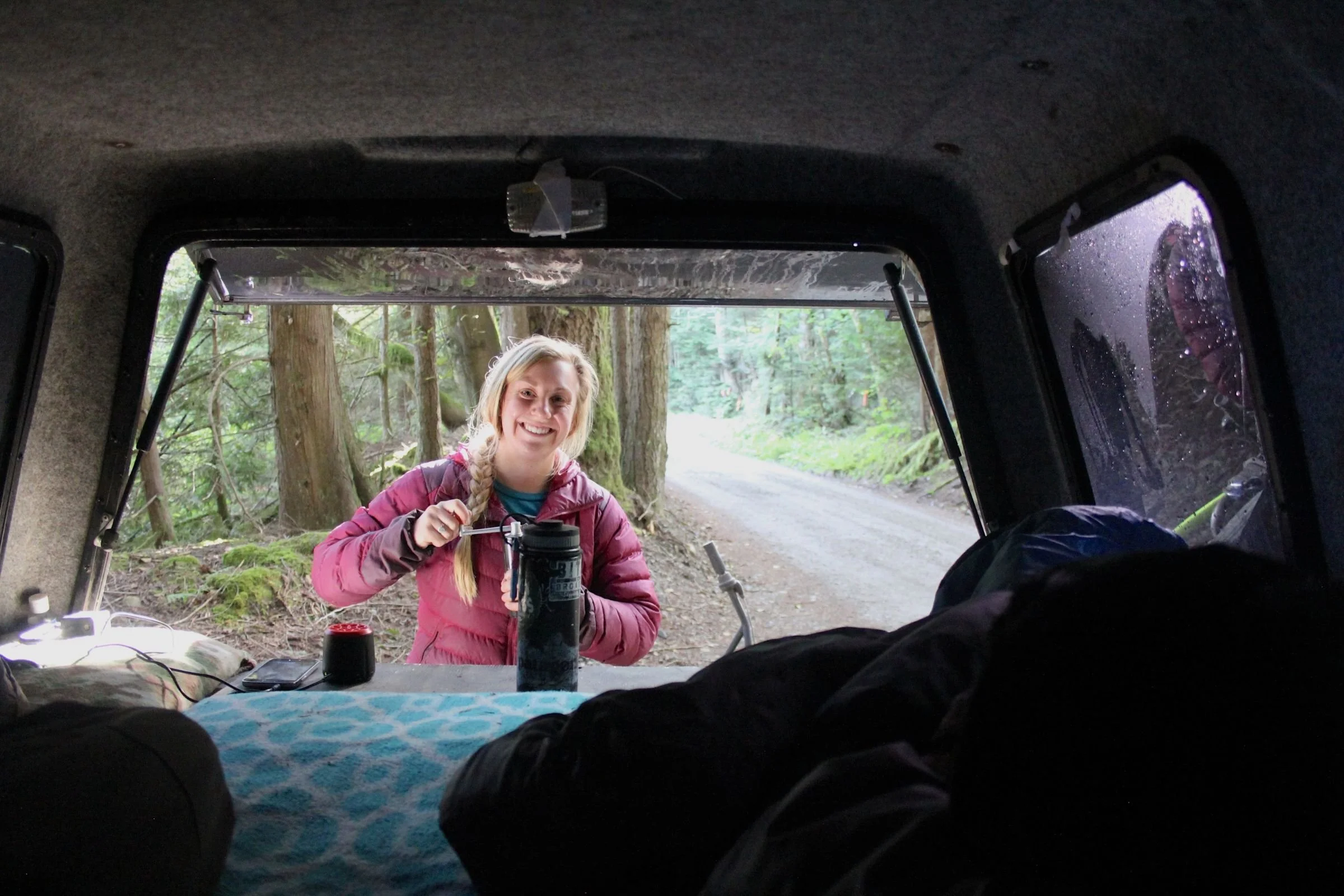 To get the most flavor out of your coffee beans, it is best to grind beans fresh just before brewing. Here, the author uses a hand grinder to grind coffee beans in camp. Photo courtesy Stasia Stockwell.