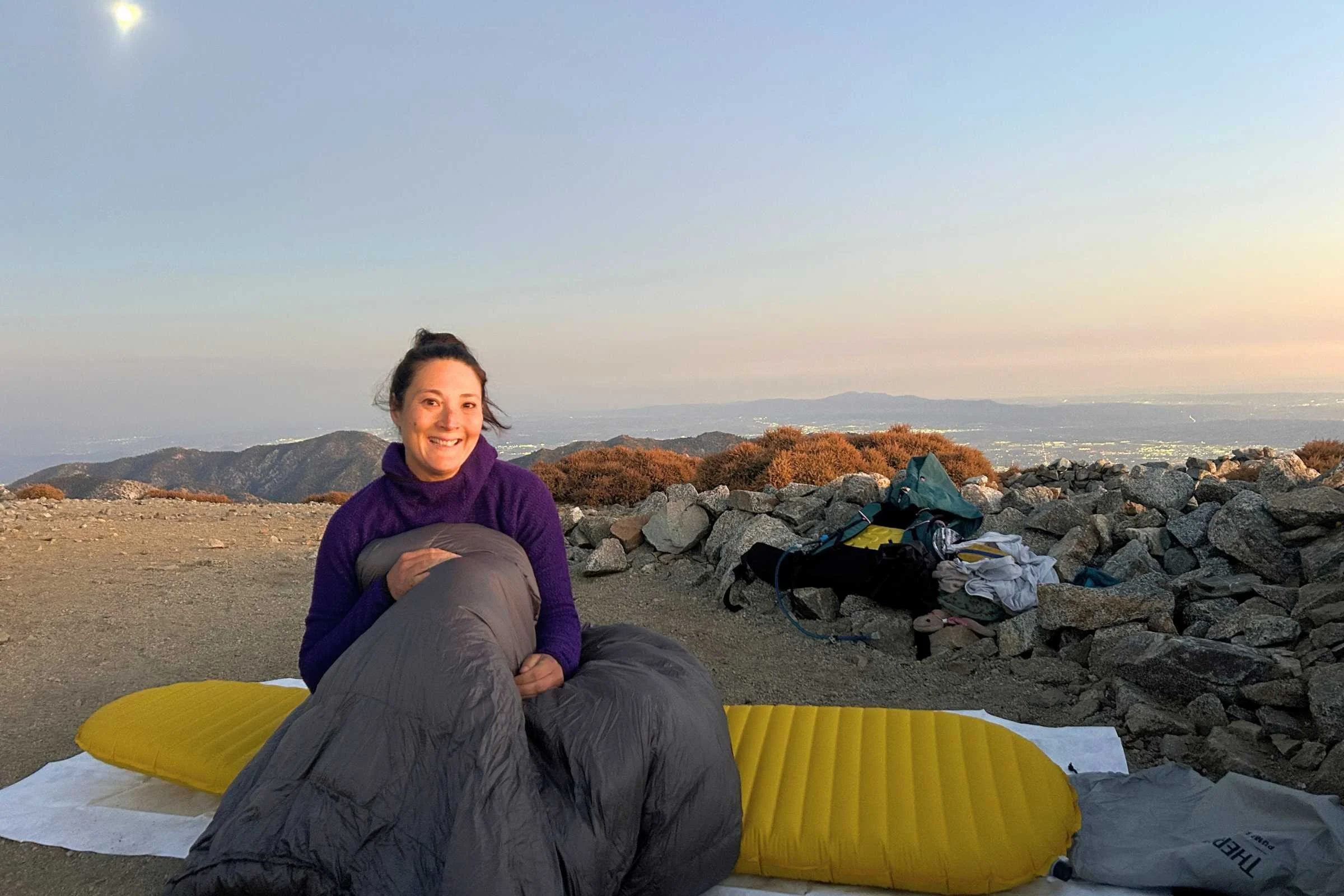 Outdoor Vitals StormLoft 15 Down TopQuilt — woman sitting on a mountain