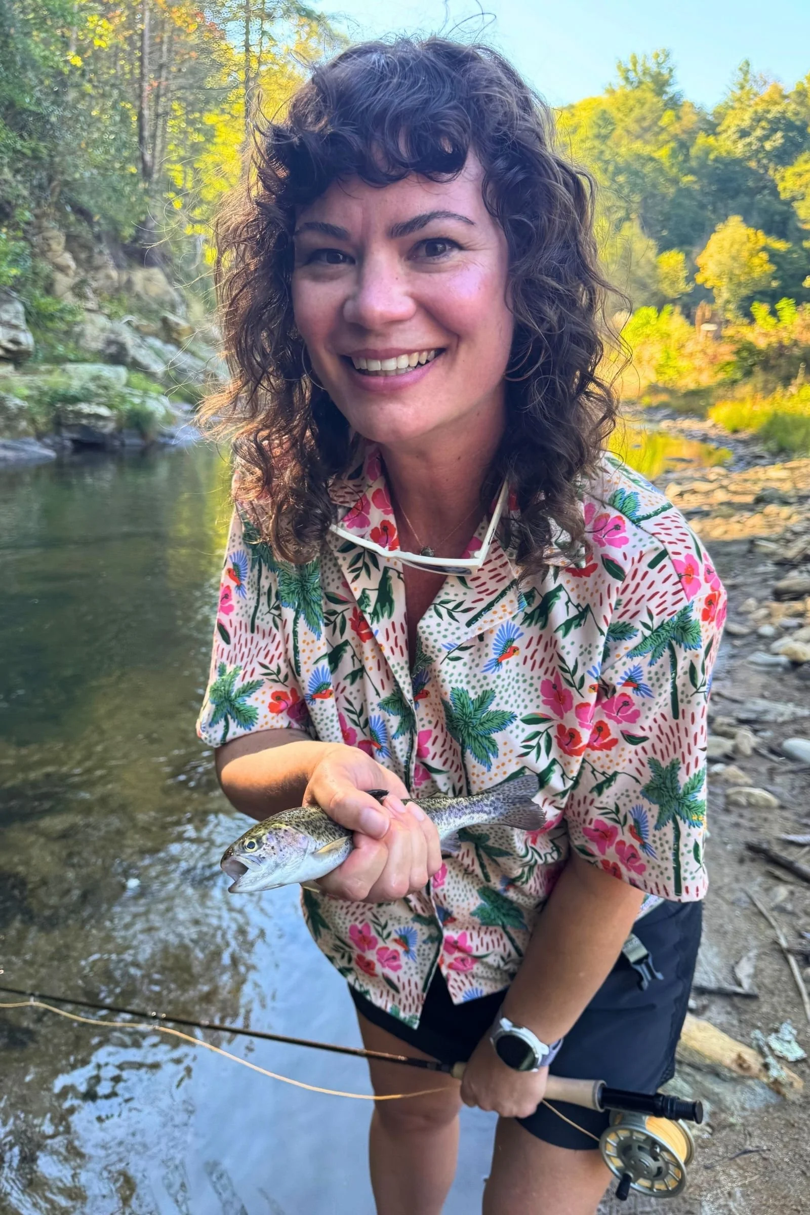 Woman holding a fish she caught with Airlite’s Aspire fly fishing kit.
