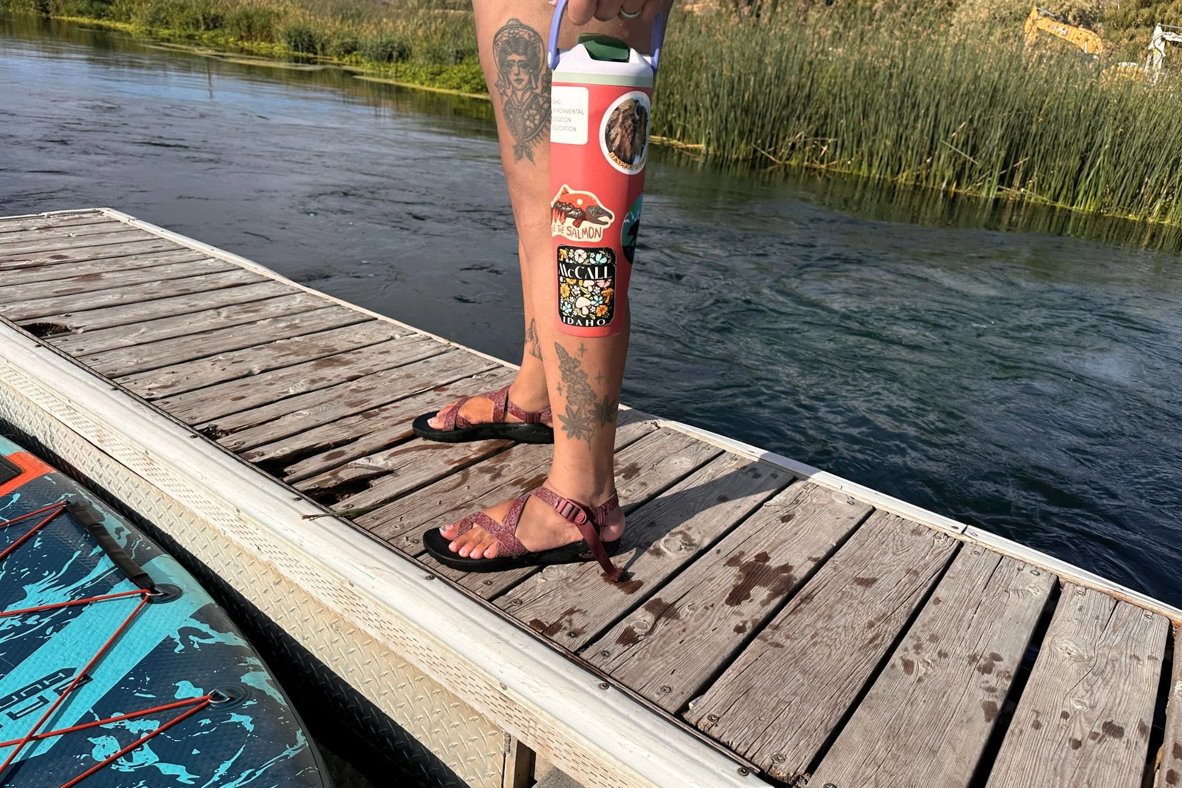 Holding the Owala FreeSip Sway while standing on a dock.