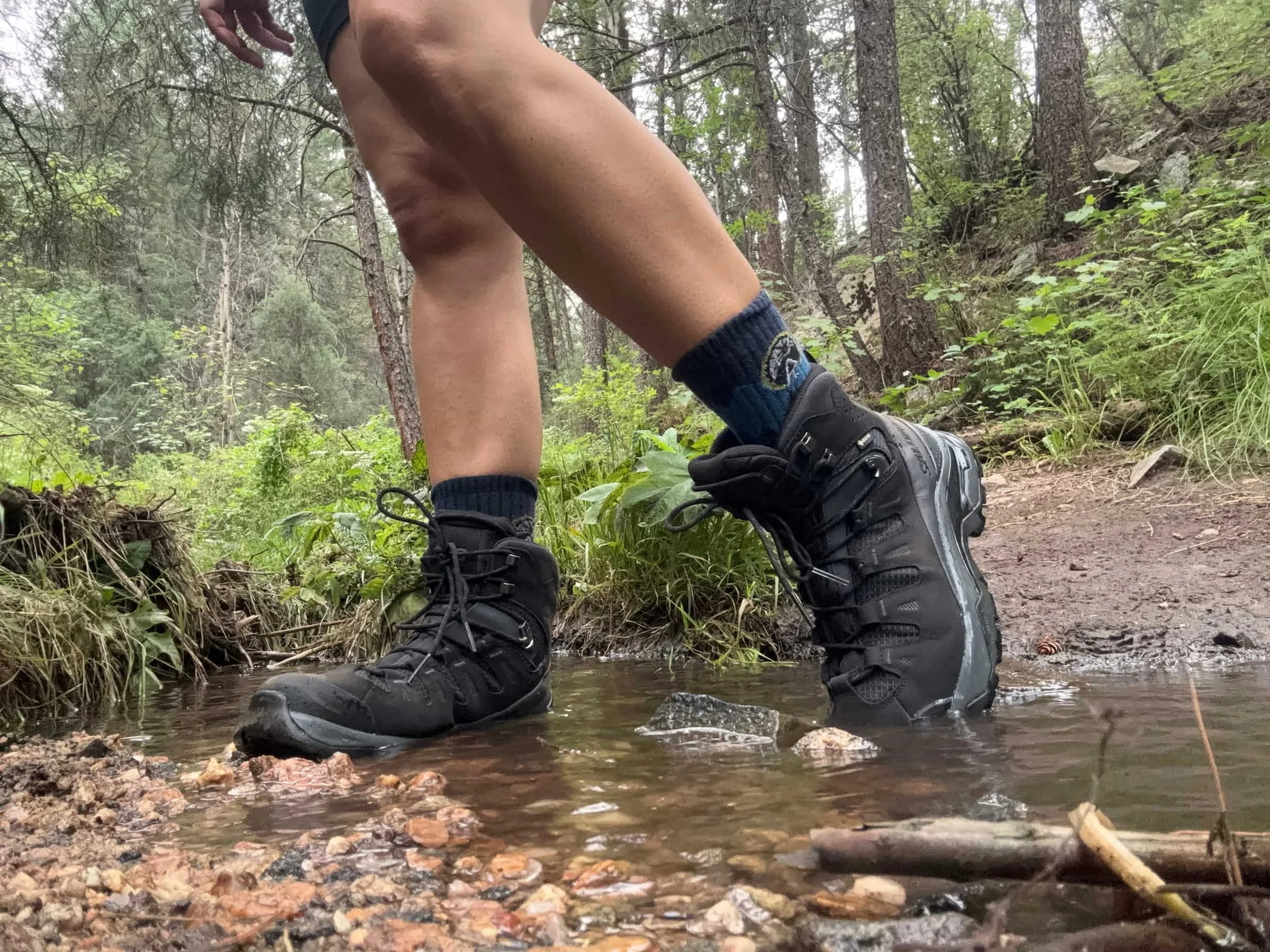 Close up of Salomon Quest 5 boots in creek