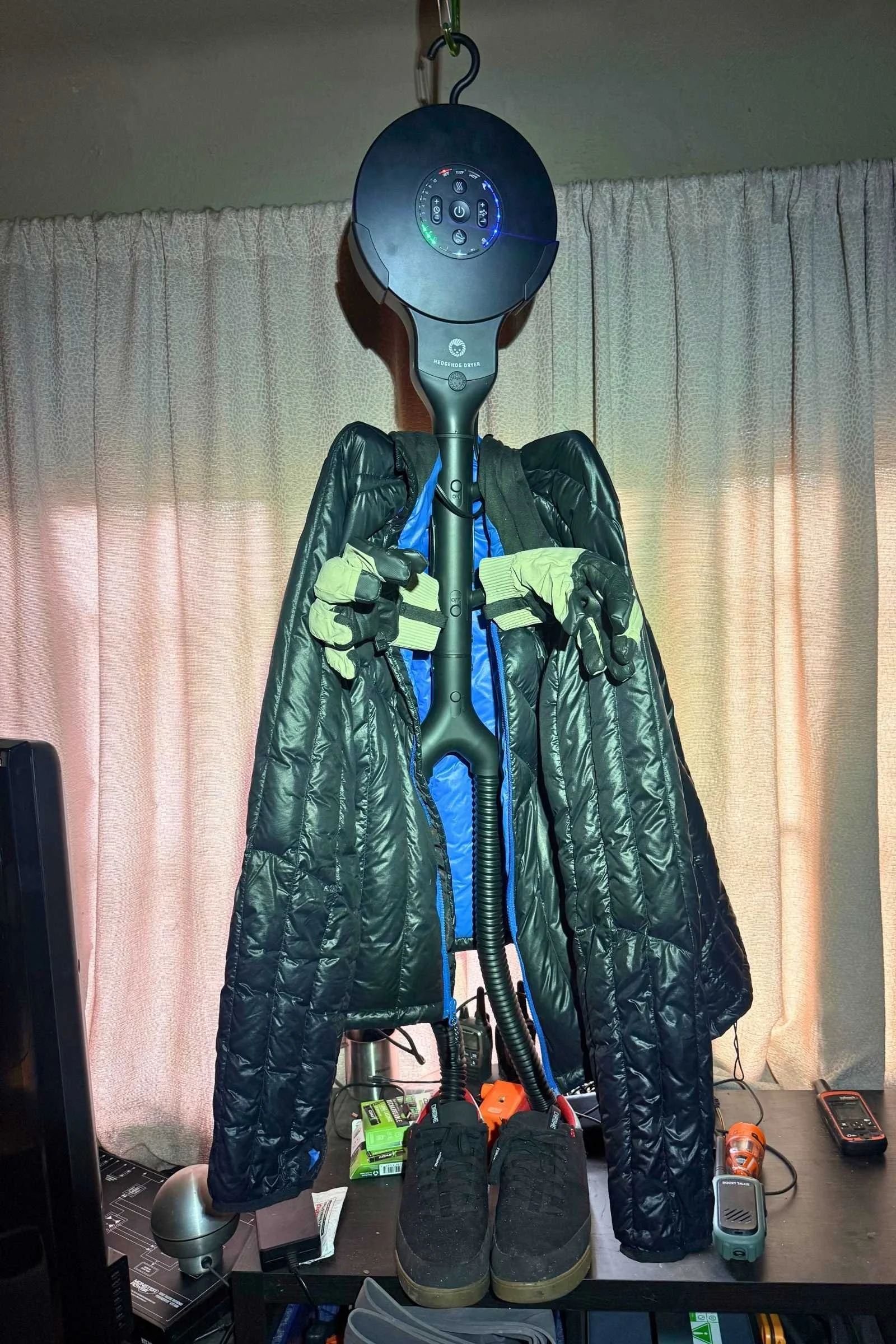 the Hedgehog Dryer Buddy Black Ionic i3 drying a jacket, ski gloves, and footwear