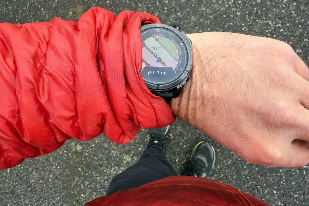 Man wearing a red jacket and the Garmin fenix 8 AMOLED Sapphire GPS watch.