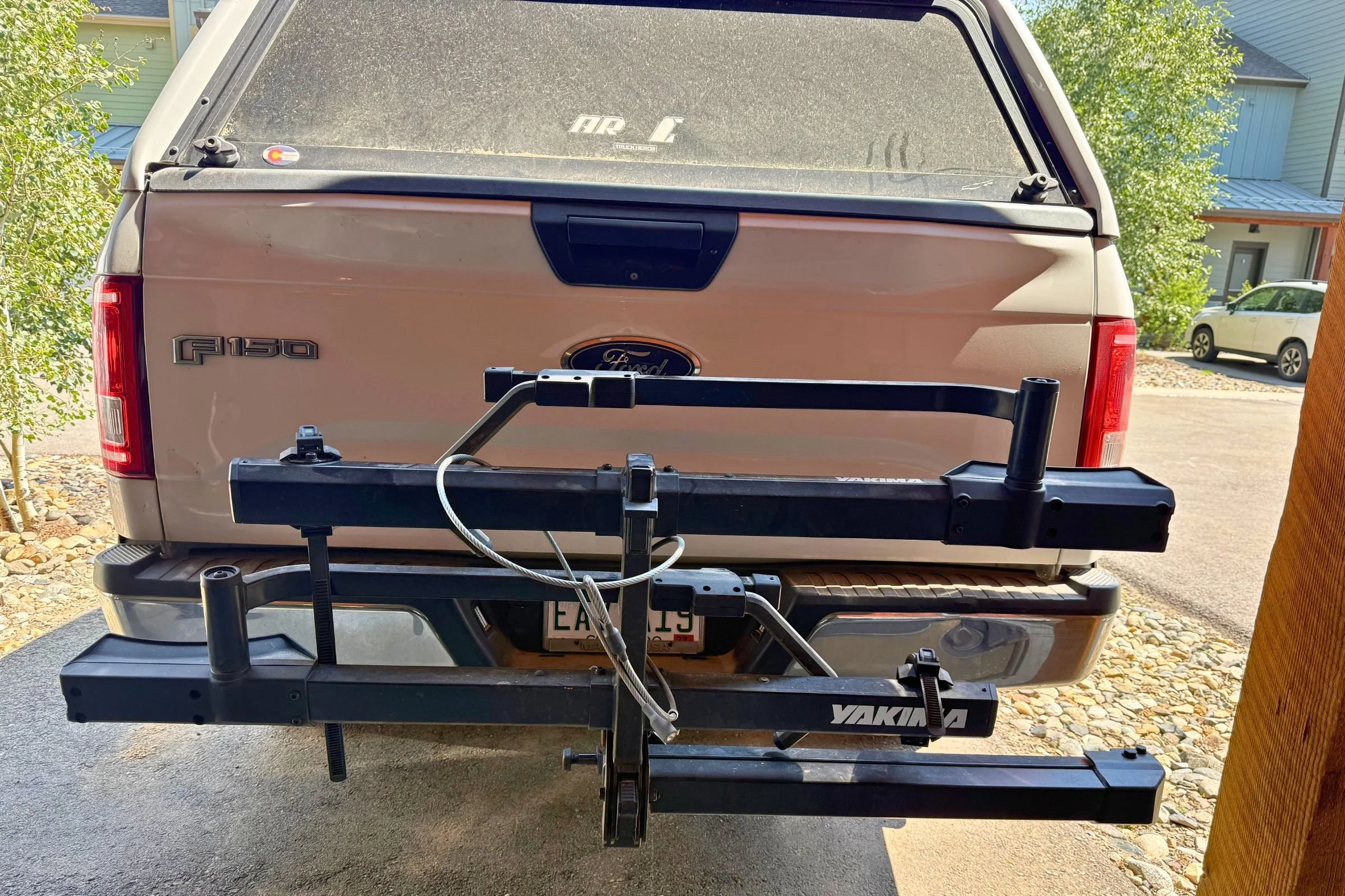 Yakima StepUp Swing 2” Hitch Bike Rack folded flat against the truck when not in use.