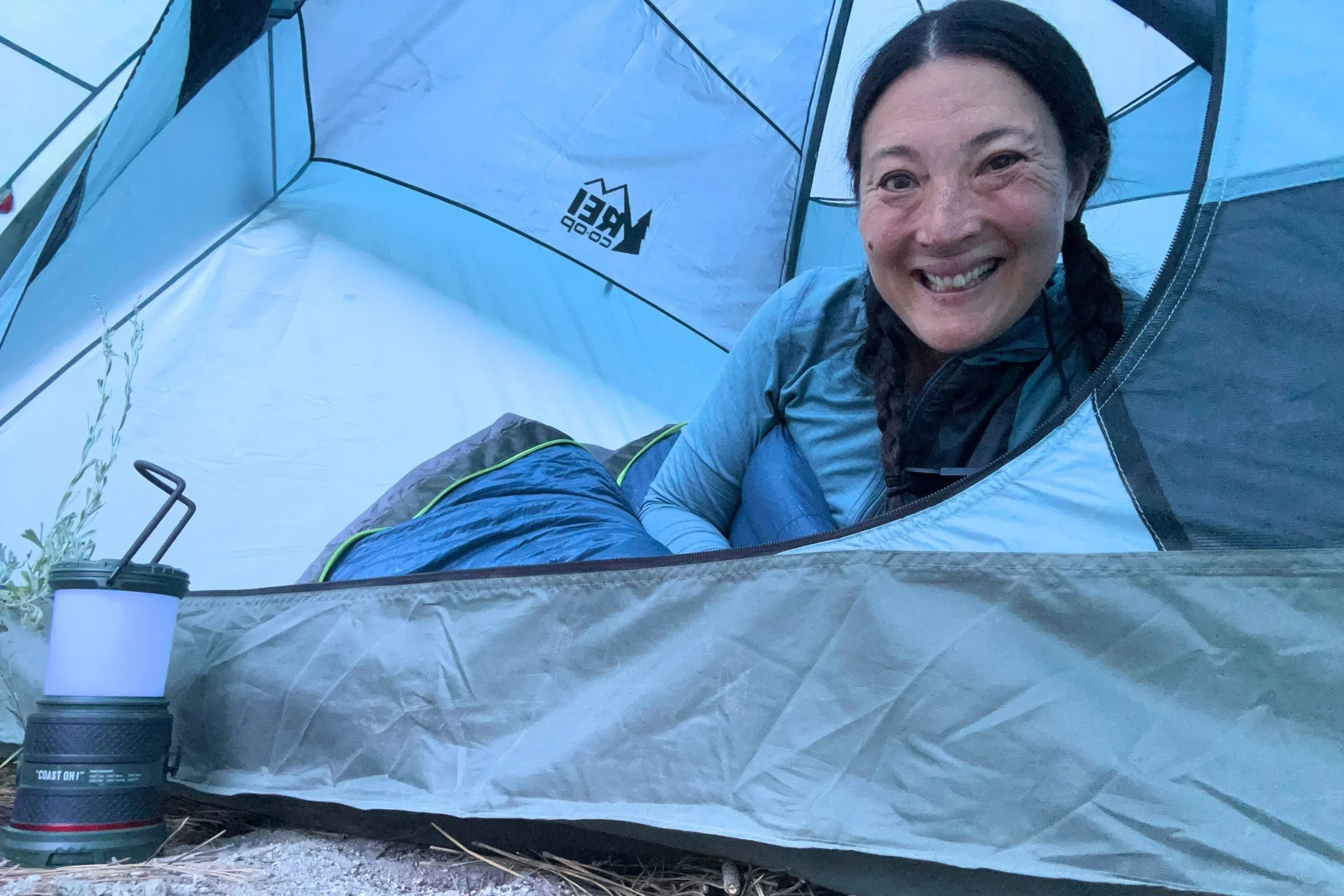 The author Liz Thomas inside a tent and underneath the Exped Terra sleeping bag.