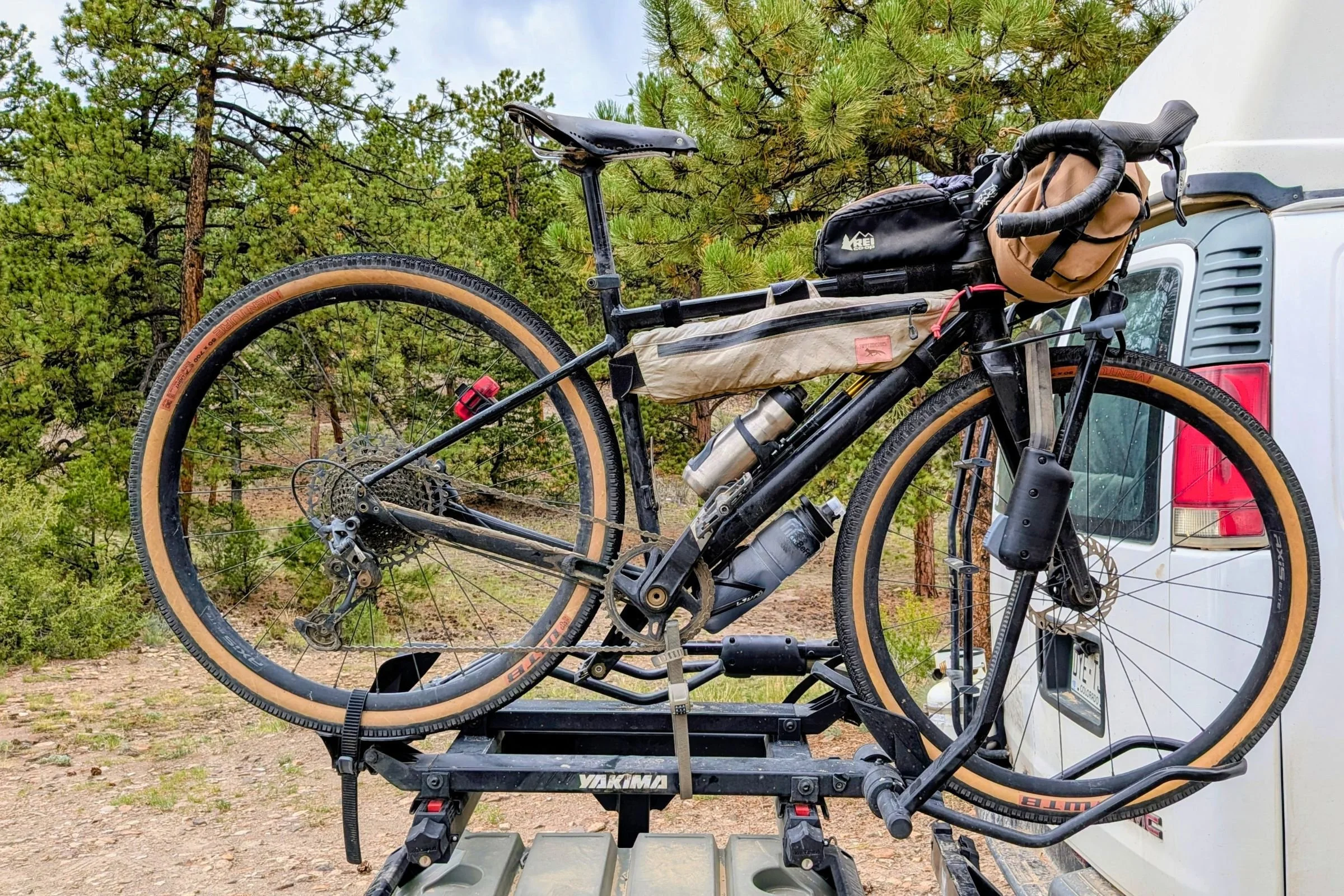A bicycle is mounted on the back of a truck with a Yakima EXO DoubleUp 2-Bike Hitch Rack.