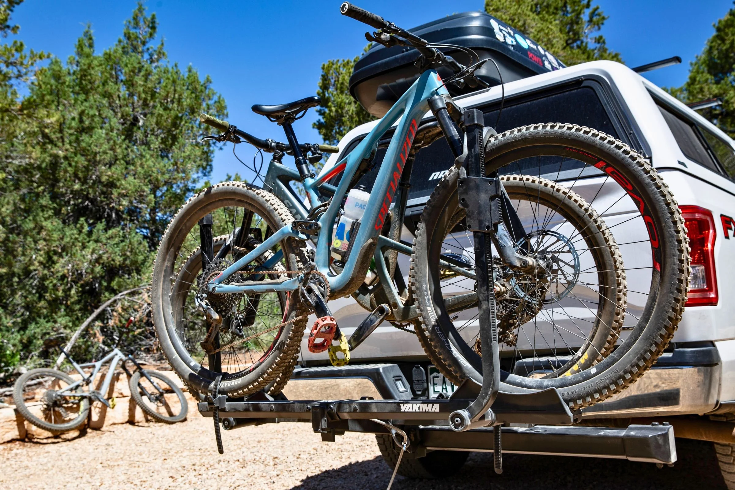 Bicycle loaded on the Yakima StepUp Swing 2” Hitch Bike Rack mounted to the rear of a truck.