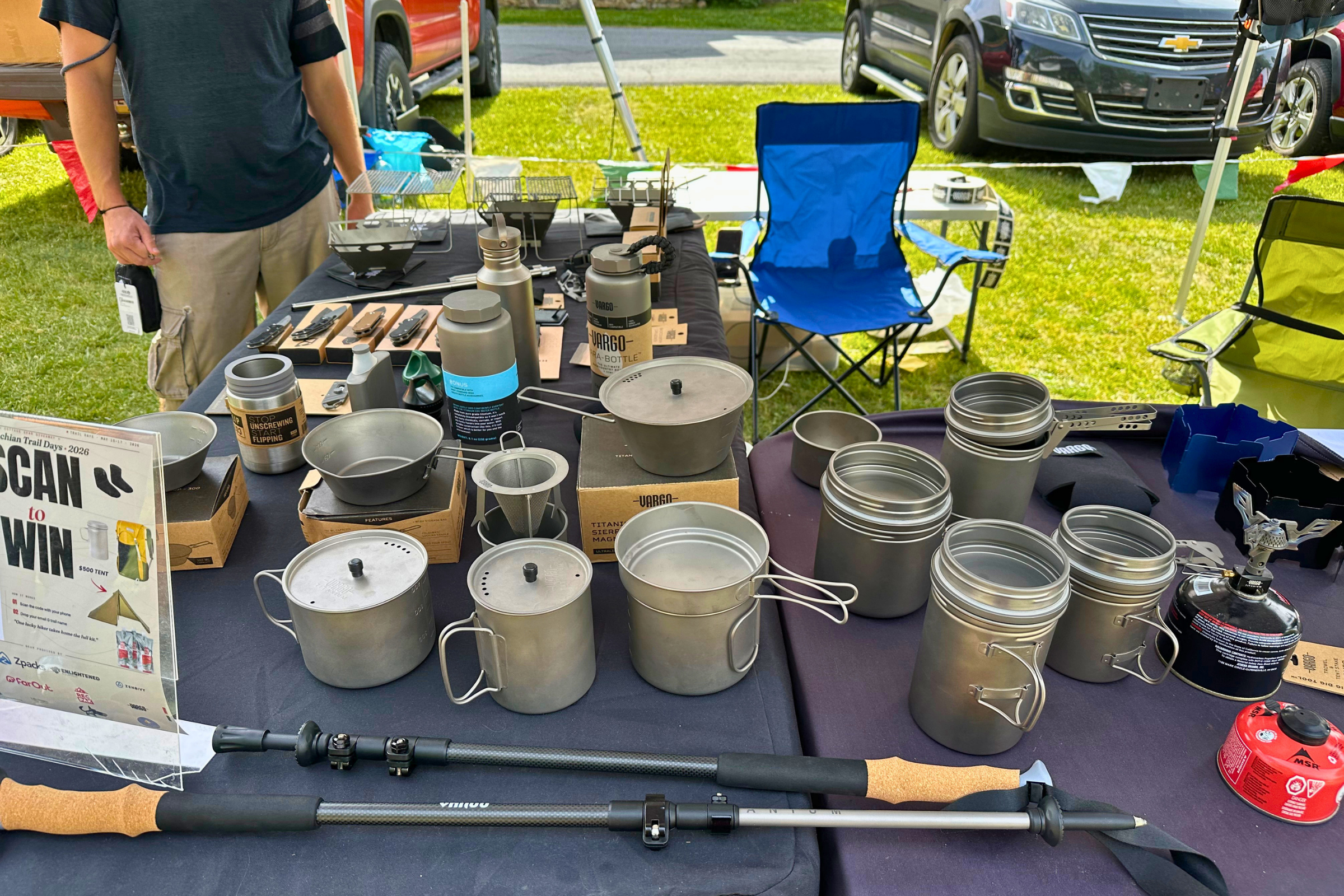 At table at AT Trail Days fill of backpacking pots, knives, grills, and other fun accessories