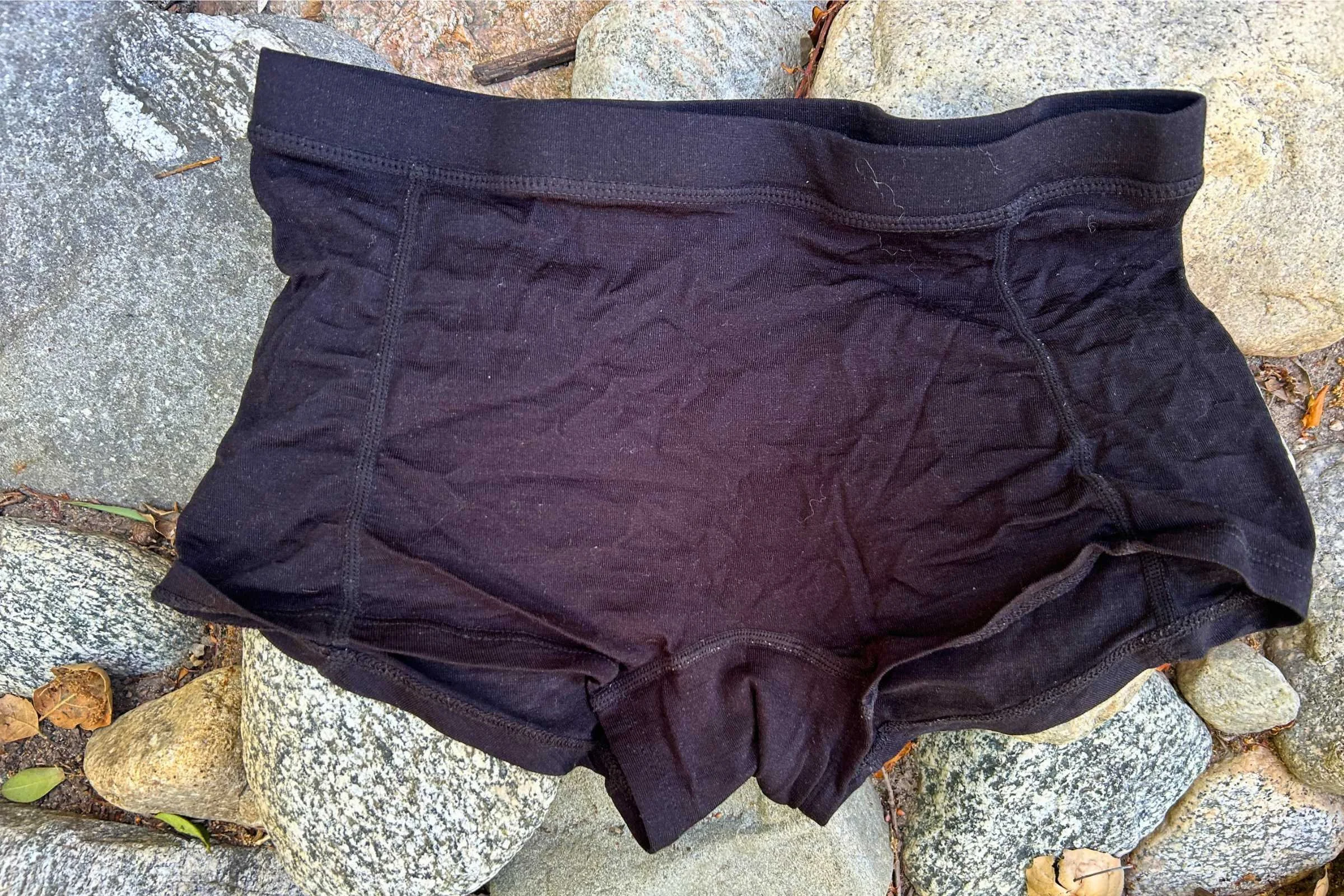 Ridge Merino Boy Short after multiple use/washes displayed on a rocky background