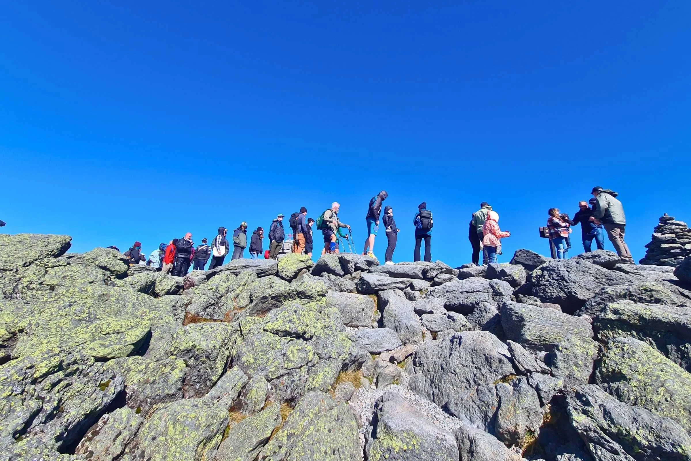 The Mt Washington summit queue on a sunny but chilly fall day. Photo by Aubri Drake.