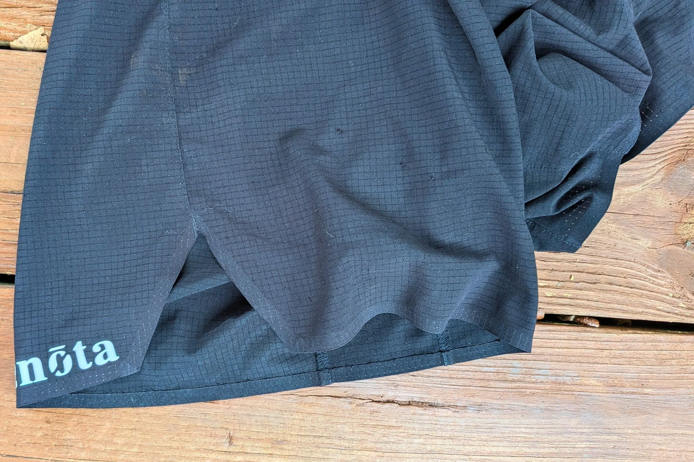 Close-up of the logo on the back of black Terignota Sendero Shorts.