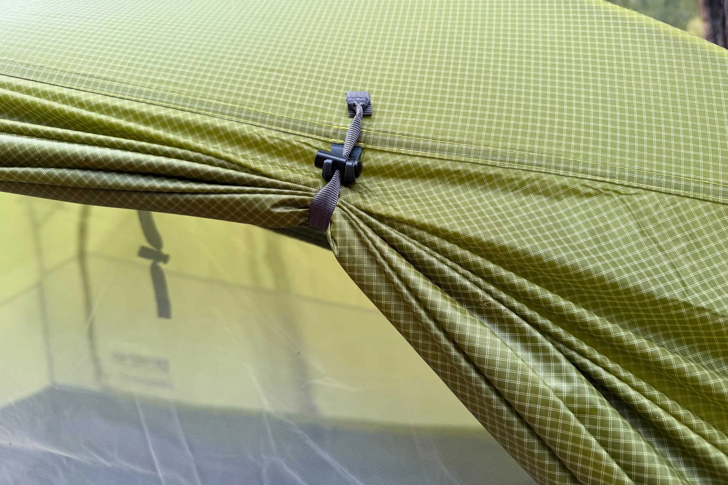 The rain fly fabric seems incredibly durable after testing; here the rain fly is shown pulled back with a door cinch toggle.