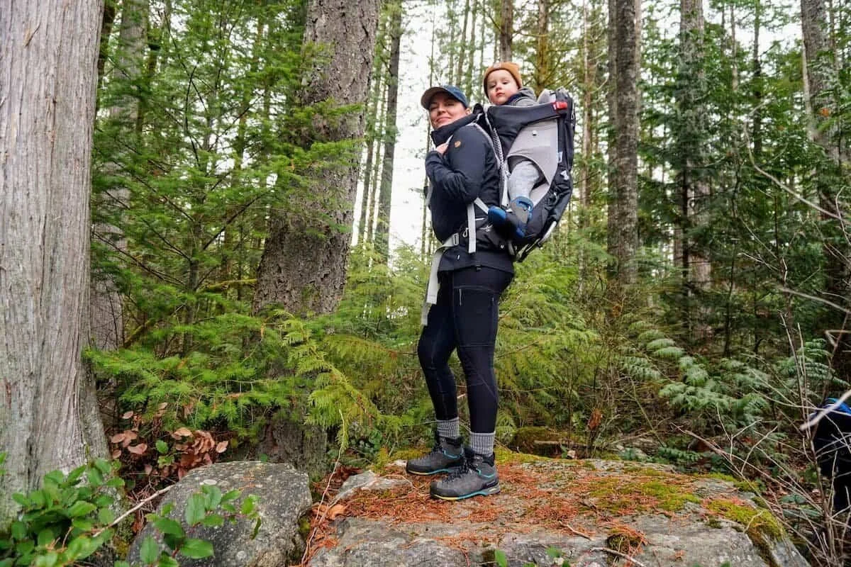 ebony roberts hiking with a baby carrier in the dense forest