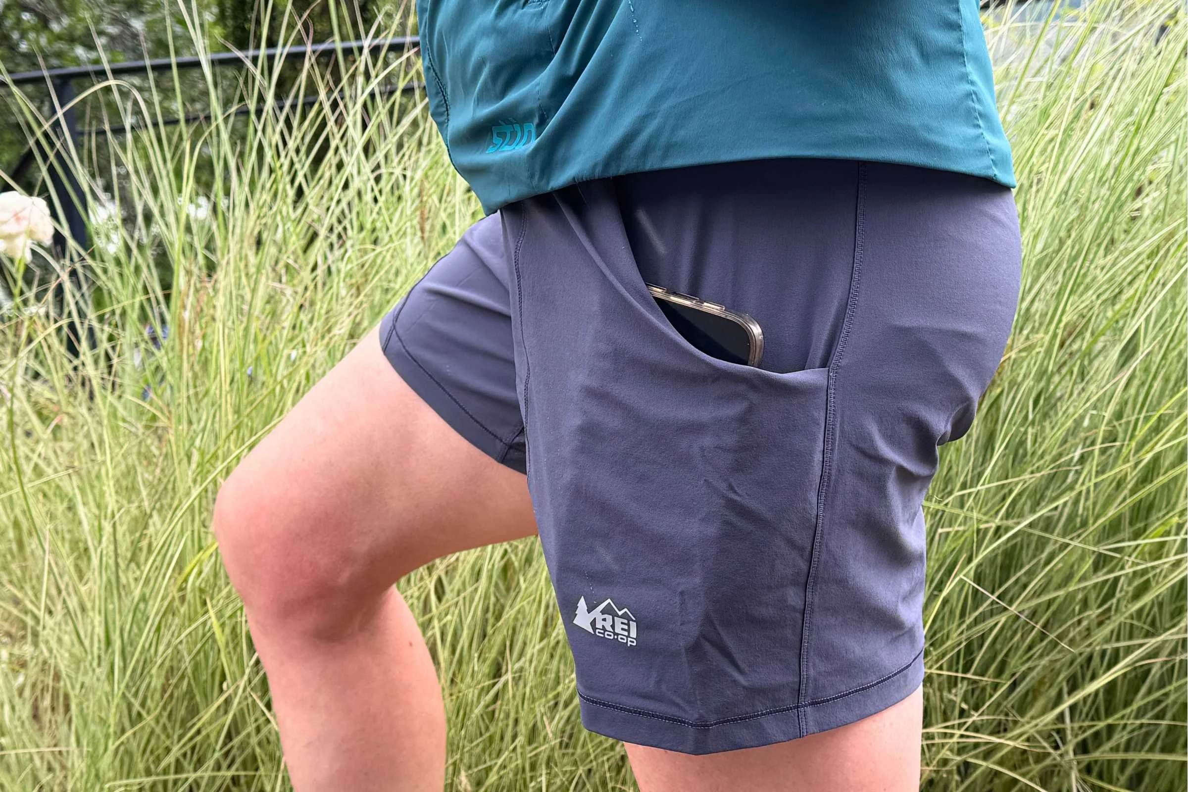 Naomi Hudetz wearing the REI Co-op Flash hiking shorts with an iPhone Max in the hand pocket