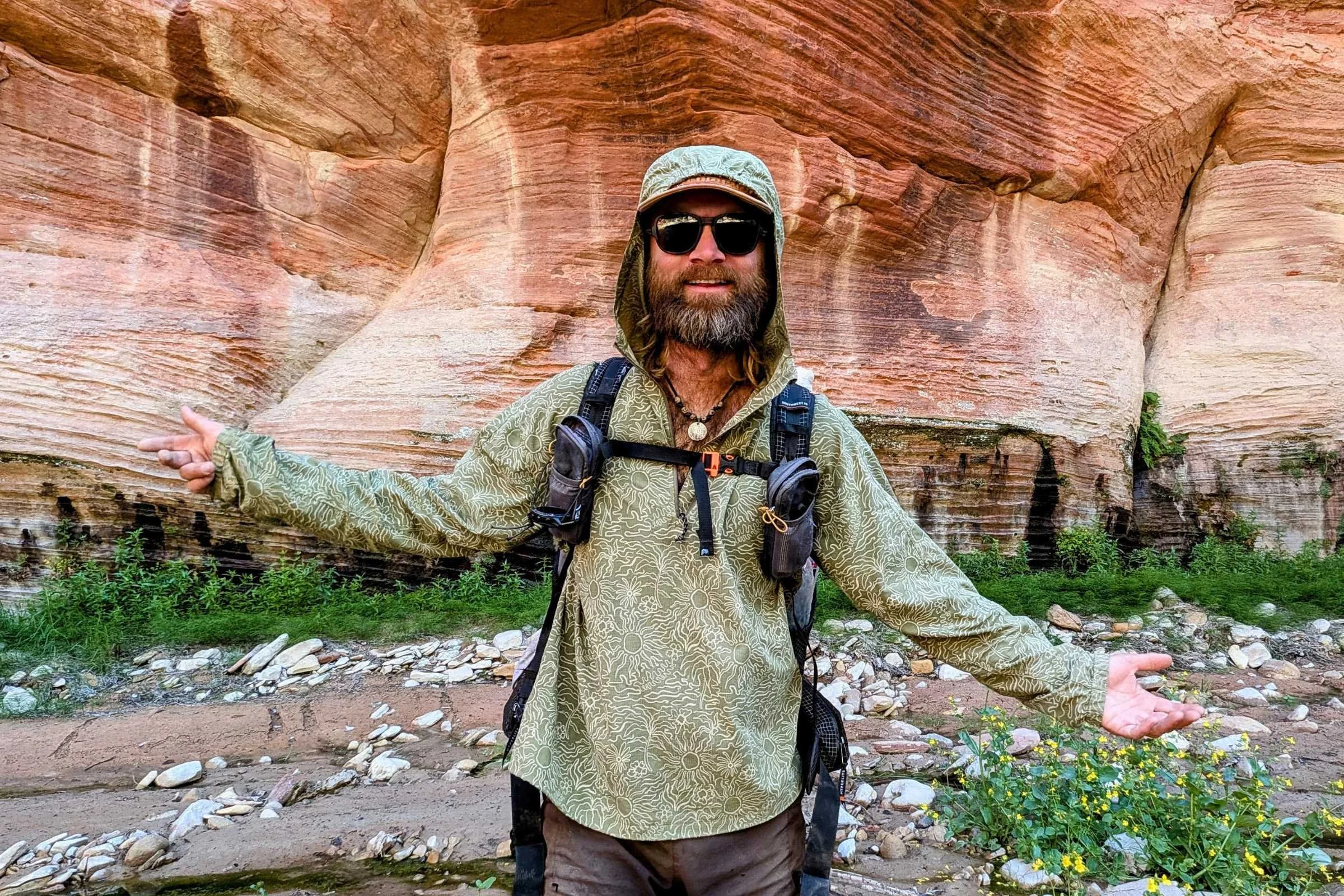 author Sam Schild wearing a green Royal Robbins Salathe Hoodie in a canyon