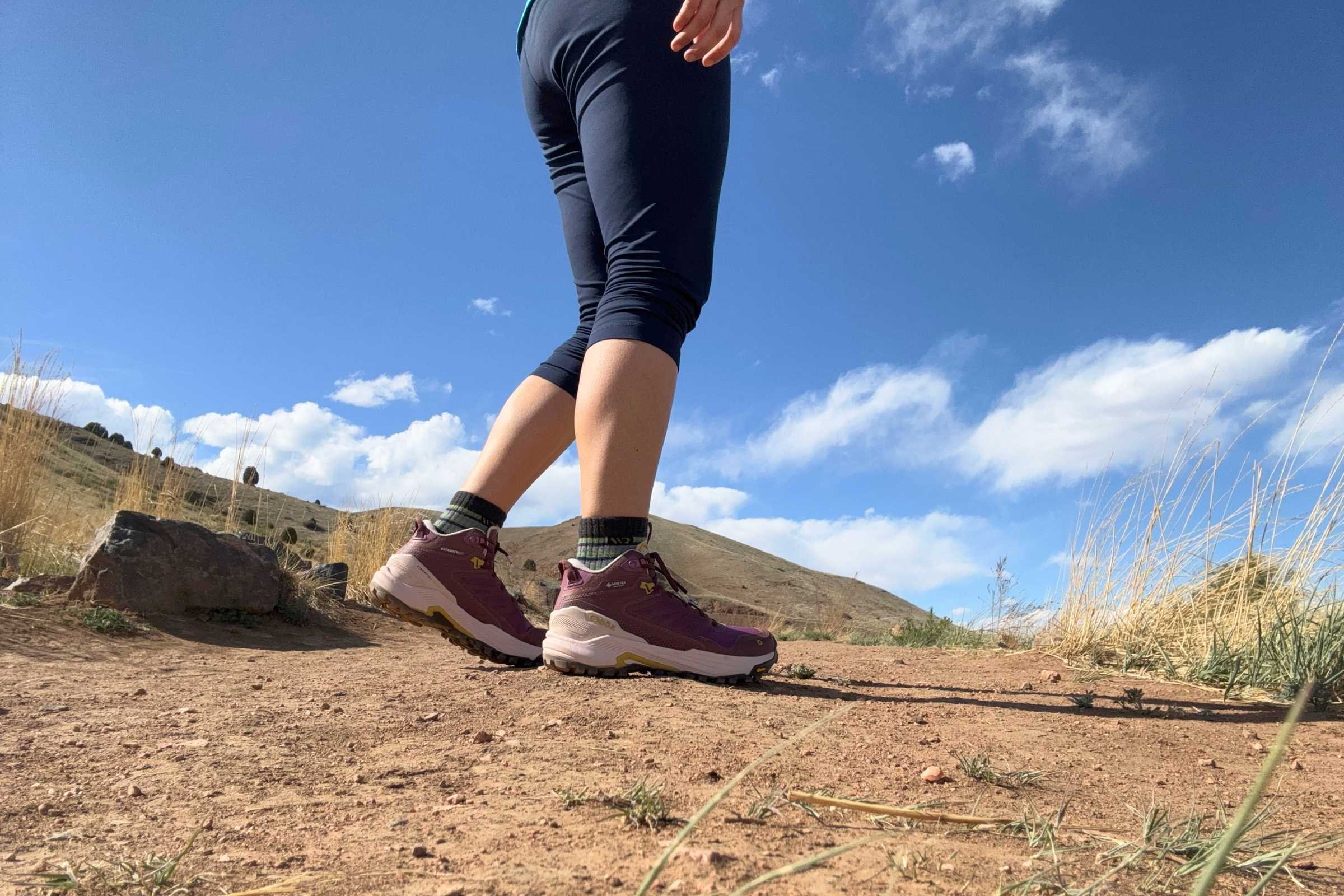 A closeup side view of the Oboz Katabatic RT Mid GTX hiking boots on a desert trail