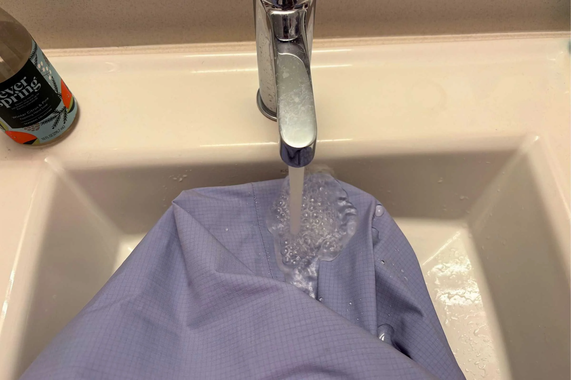 In addition to testing the jacket on the slopes, we ran the OR Carbide jacket under a sink as part of a standardized waterproofing test.