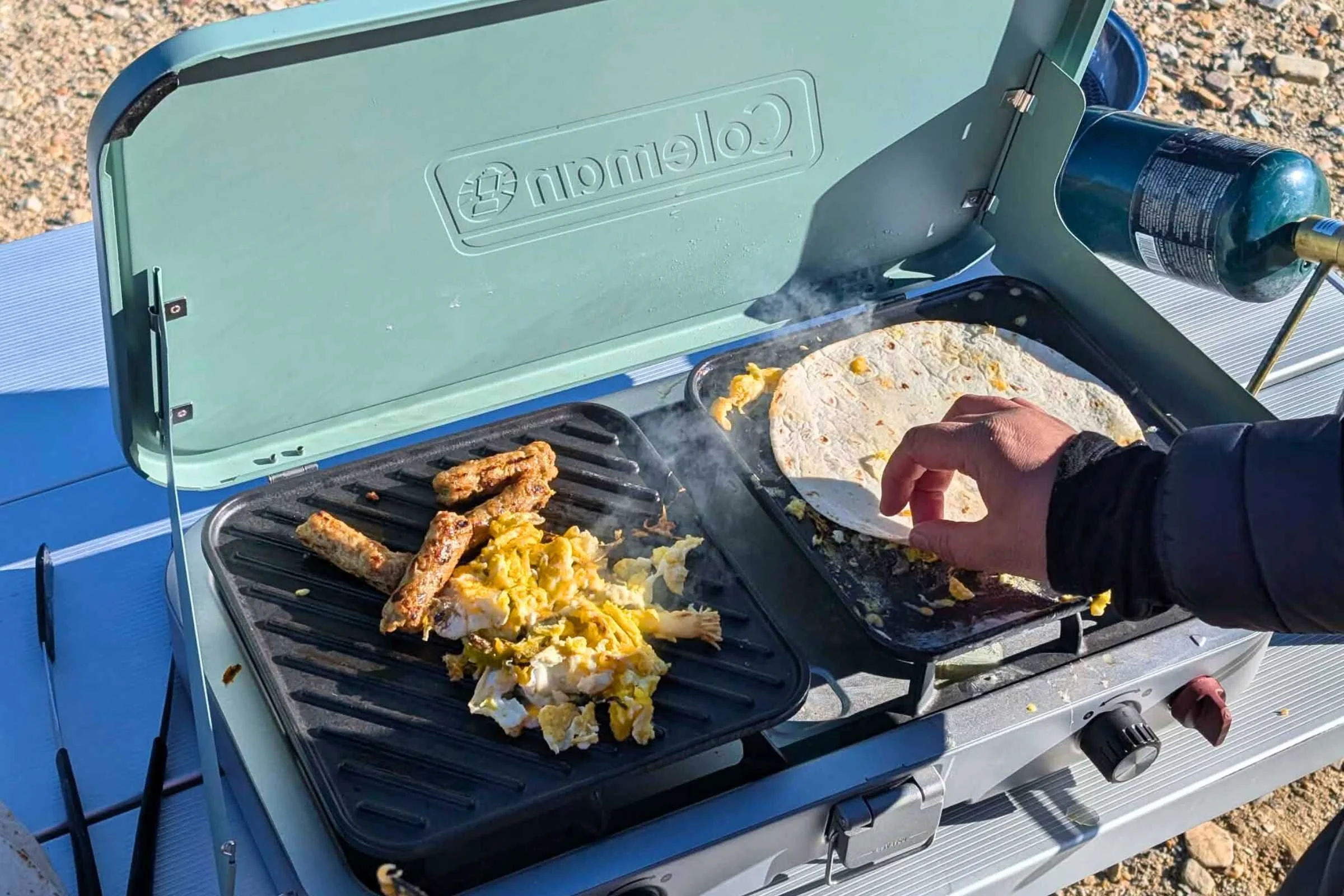 Eggs and sausage cooking on Coleman Cascade griddle