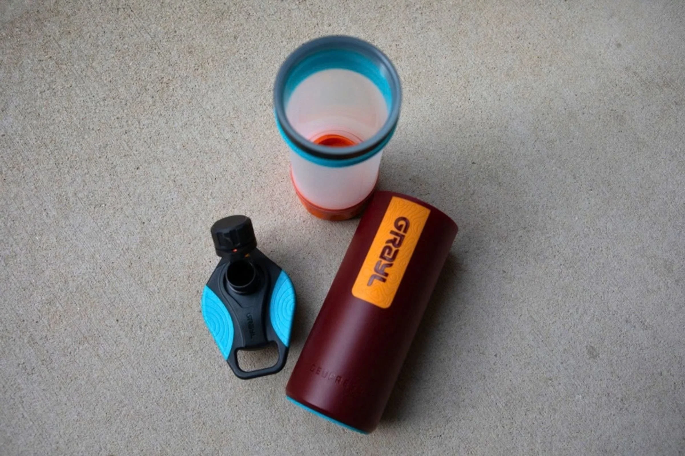 A Grayl GeoPress Purifier displayed with its component parts and accessories.