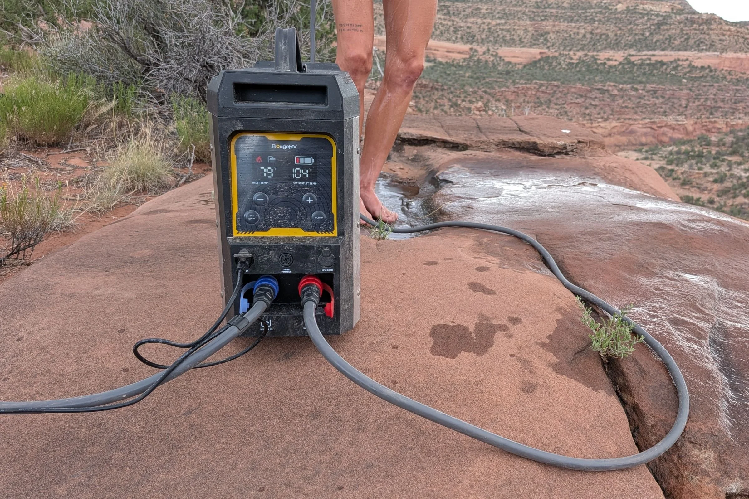 BougeRV Portable Propane Outdoor Water Heater being checked with a digital temperature meter.