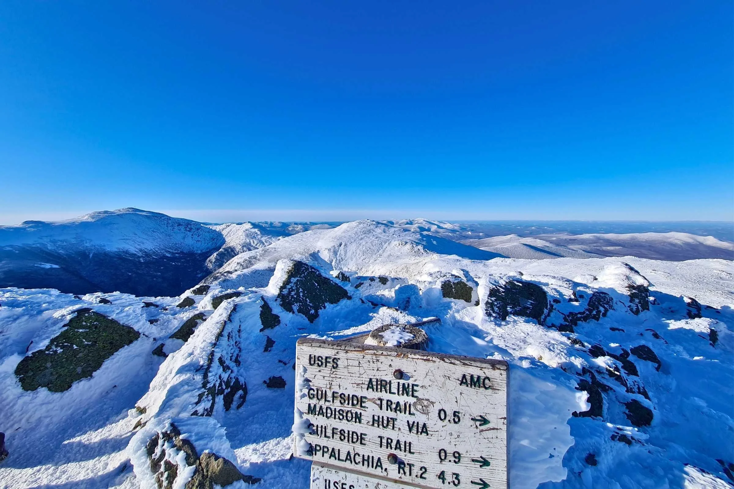 A trail sign at the summit of Mt Adams in winter. Photo by Aubri Drake.