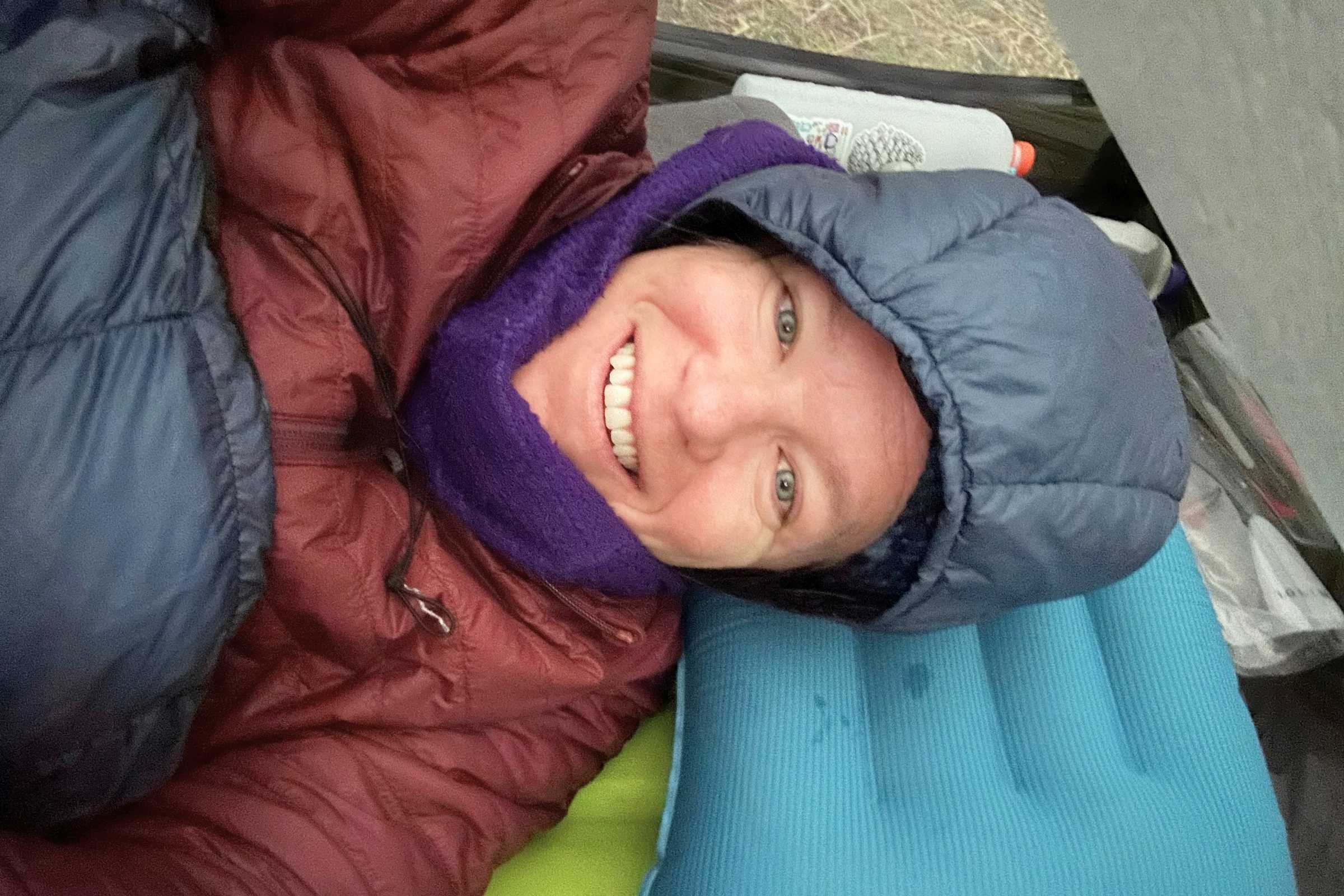 Tester snuggled up smiling after a full night's sleep using the EXPED Ultra 6.5R sleeping pad