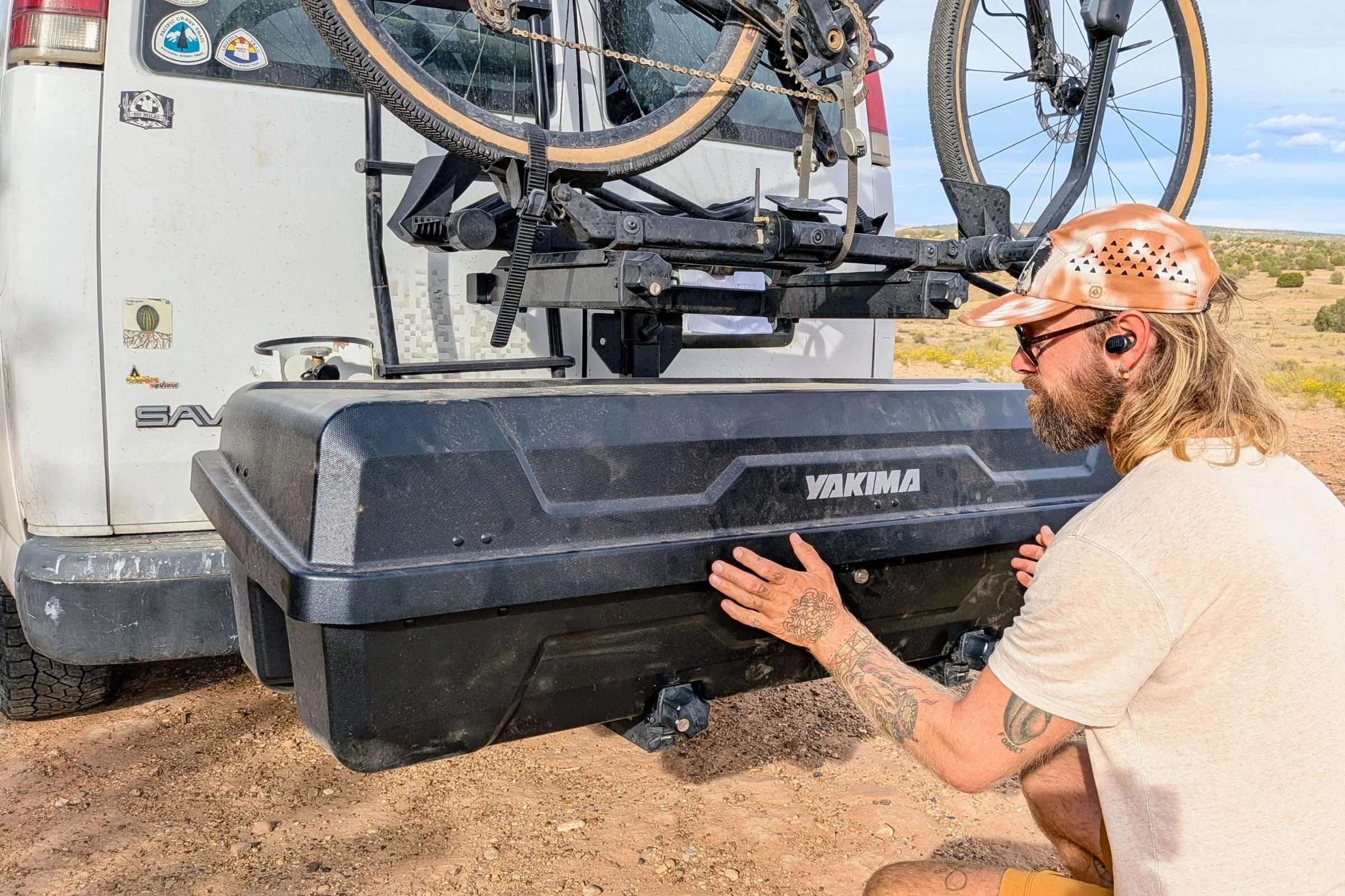 Tester preparing to open the Yakima EXO GearLocker while mounted on the EXO SwingBase