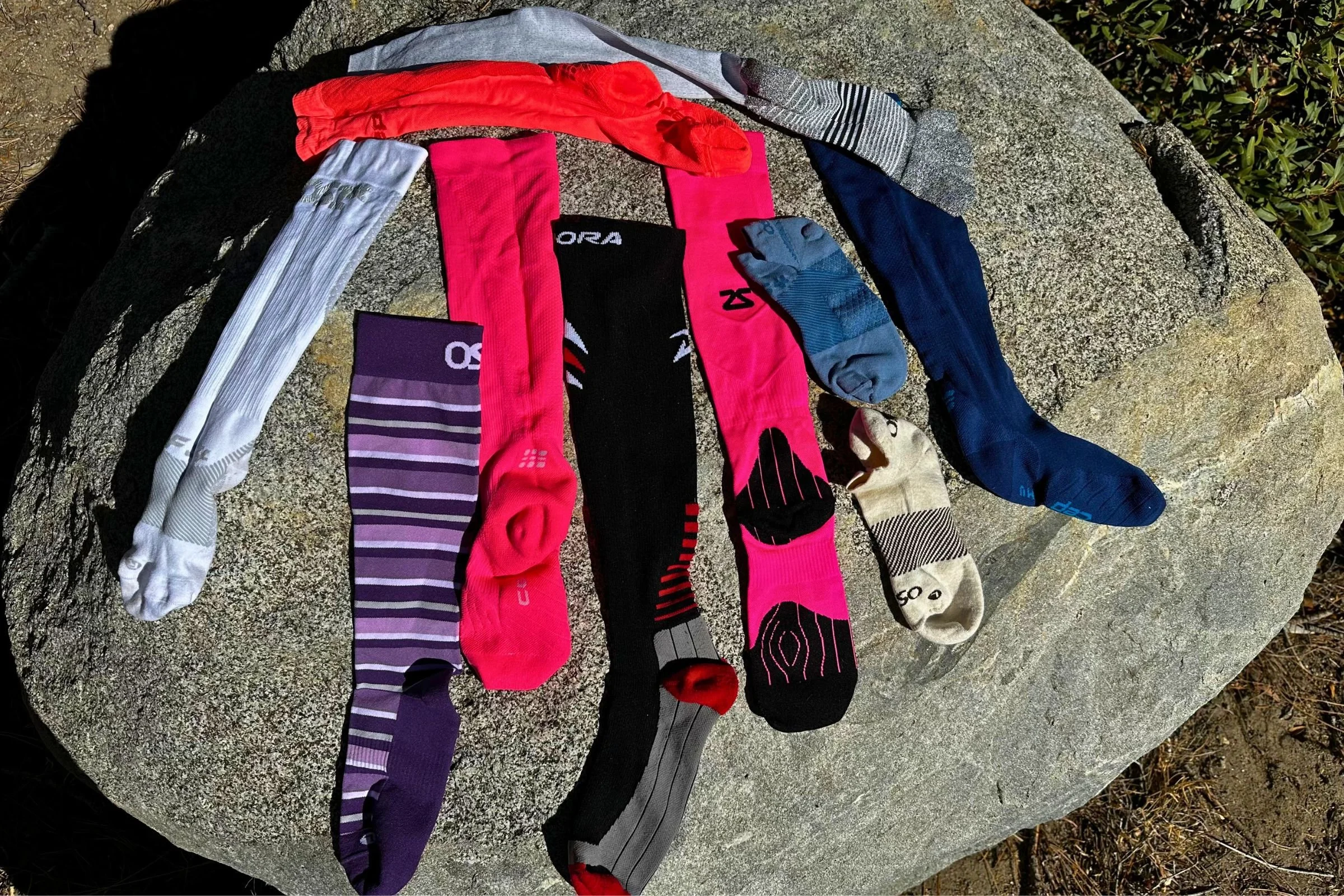 Running compression socks we tested laid out side by side on a rock