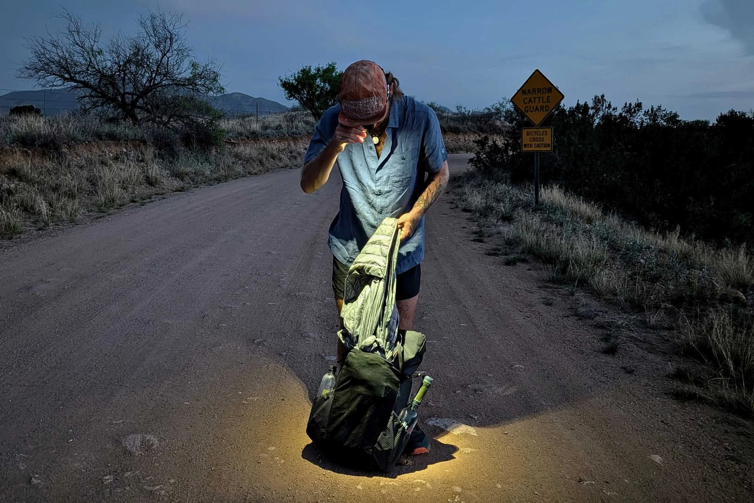 Stopping to get a jacket out before some night hiking to get to camp.