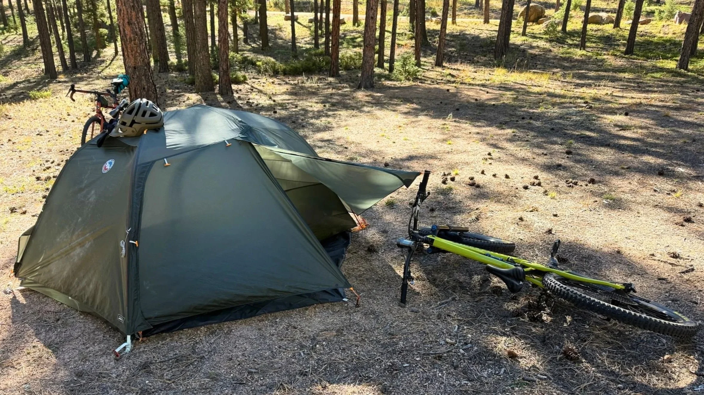 copper spur bikepacking tent in the woods with bike and helmet by its side
