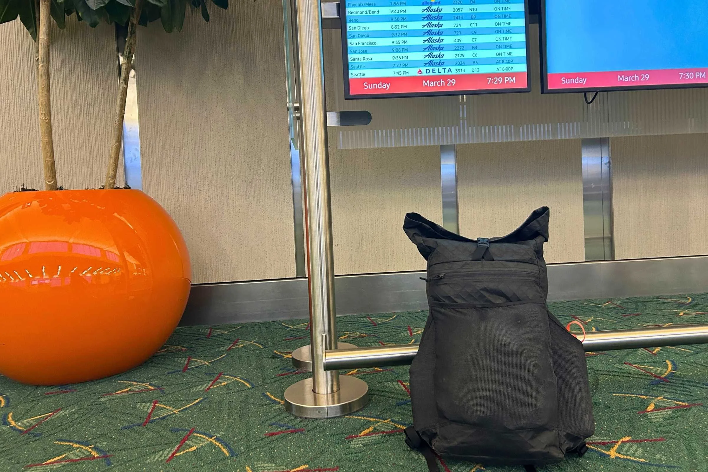 the ula ultra node 20l backpack on the ground at an airport