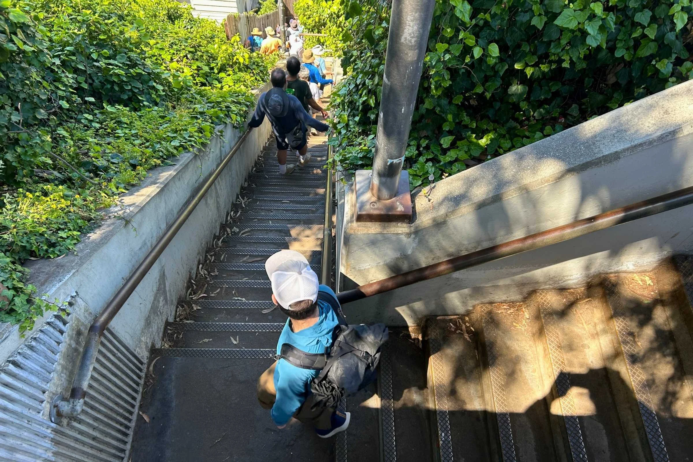 person wearing the ula ultra node 20l backpack walking down a staircase