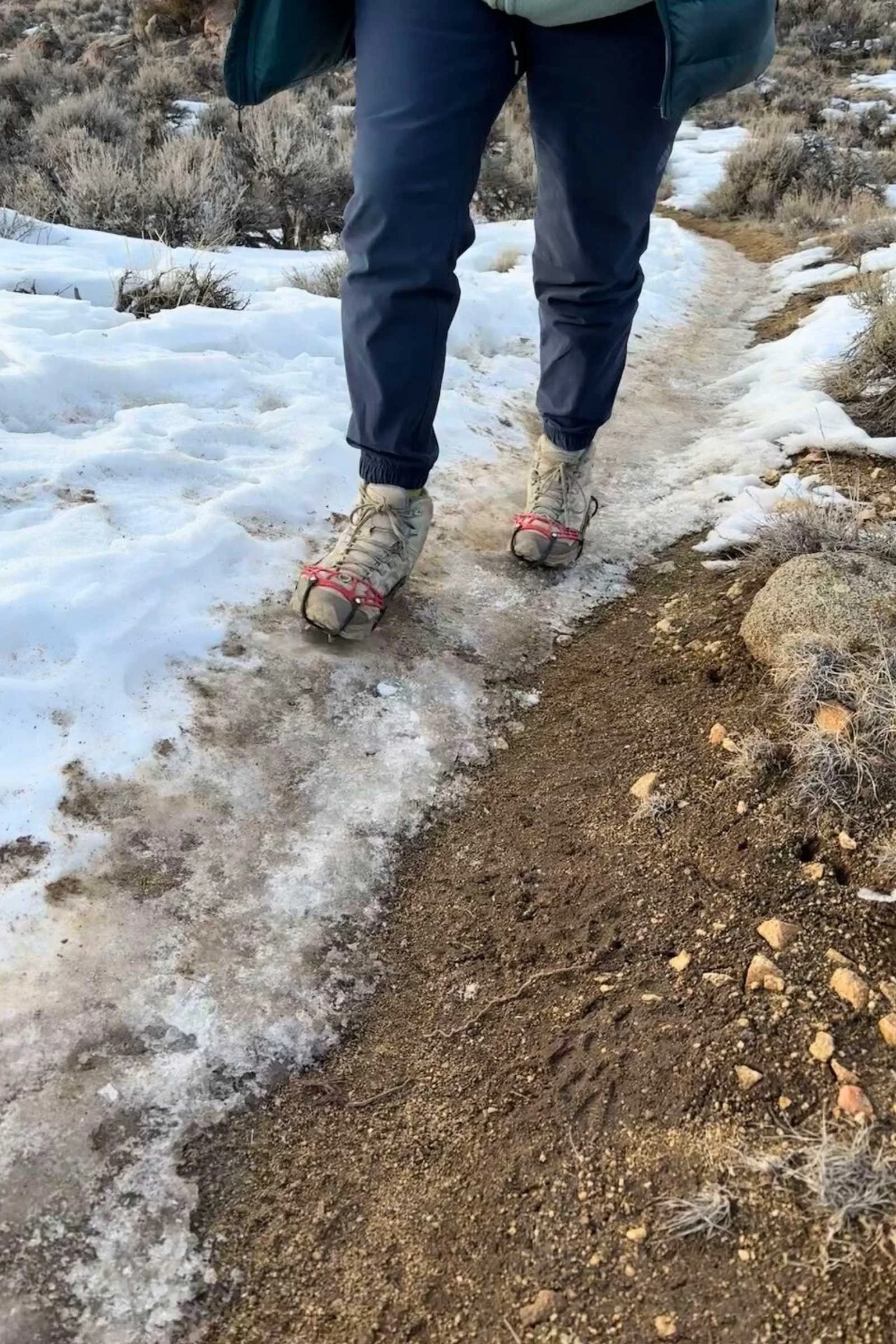 hiker walking on hardpacked snow in the kahtoola microspikes ghosts