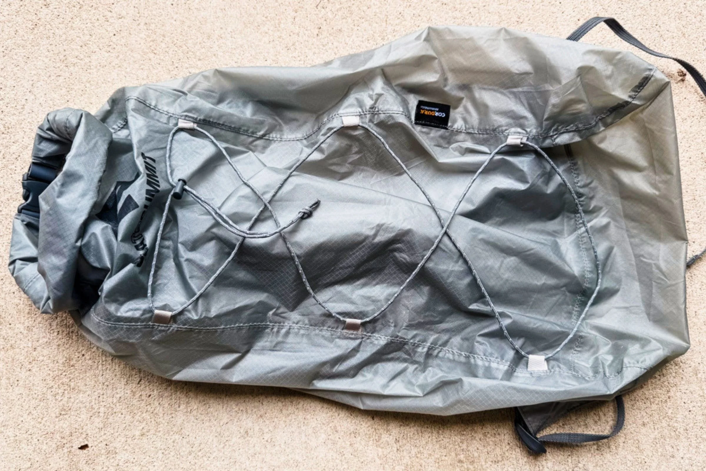 Sea to Summit Ultra-Sil Dry Daypack unfolded, showing its front bungee cords and roll-top opening