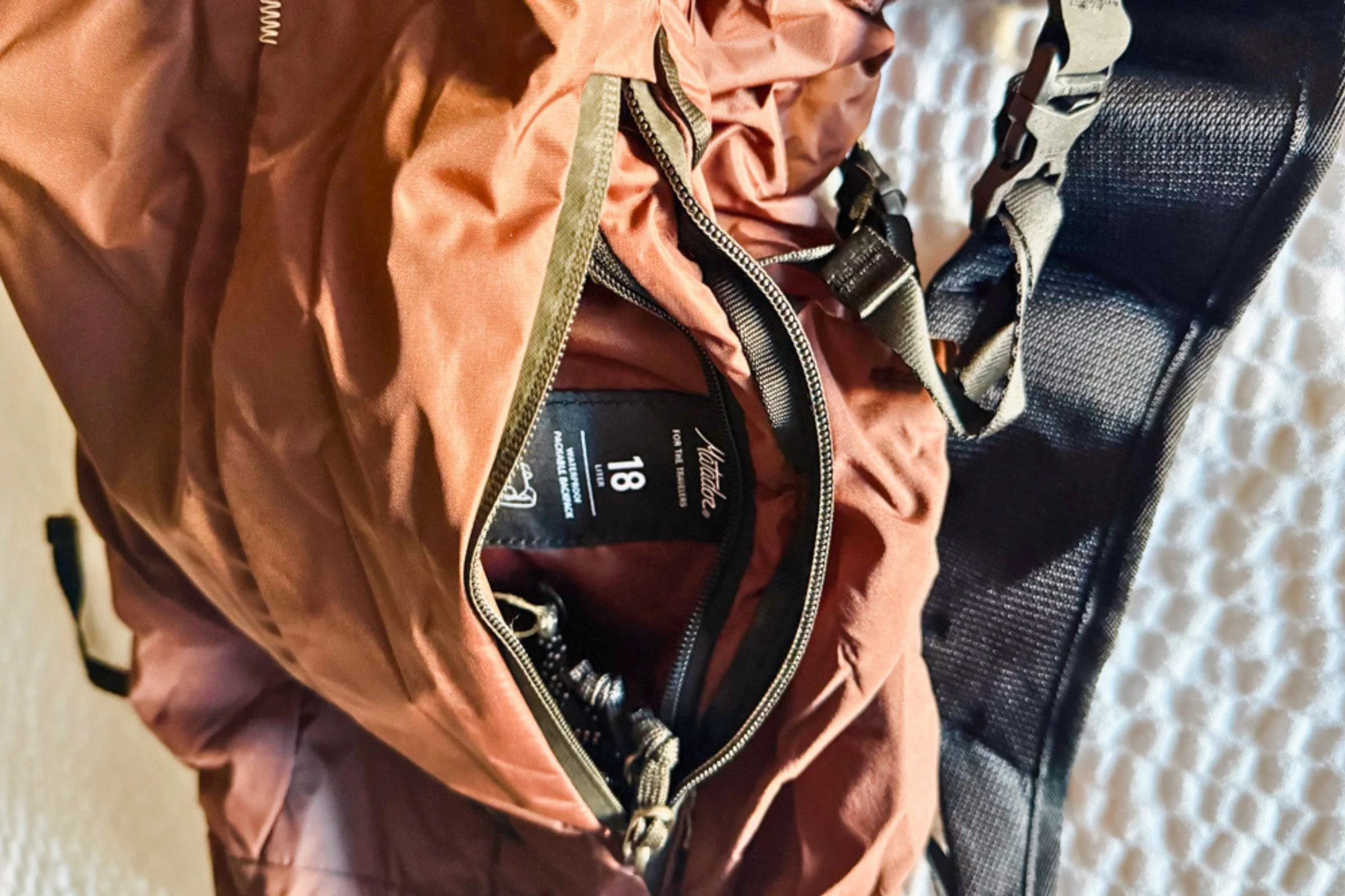 Close-up of the open front pocket and smaller inner pocket on the Matador 18L Waterproof Packable Backpack.