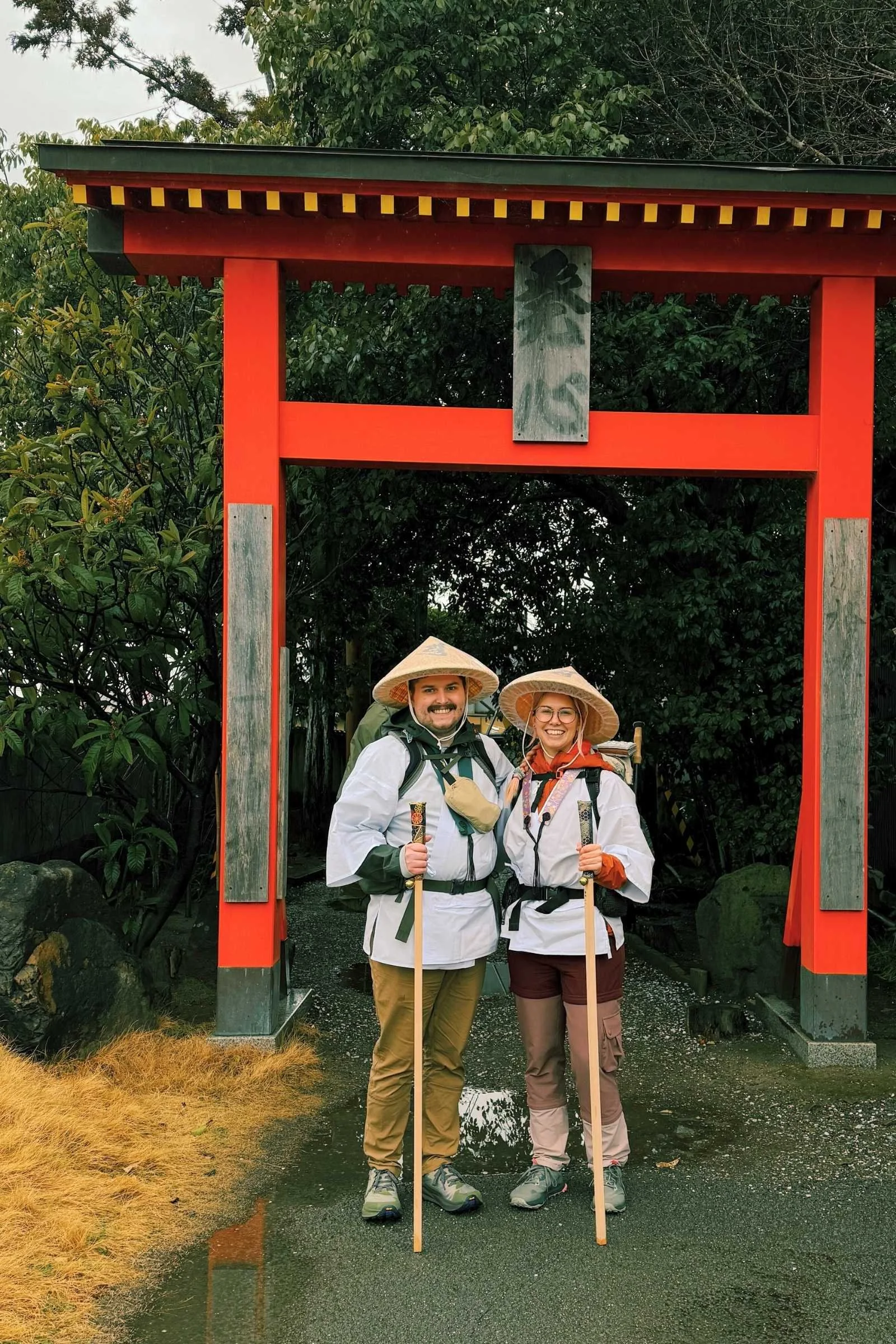 Two pilgrims stand at the entrance to Temple 1
