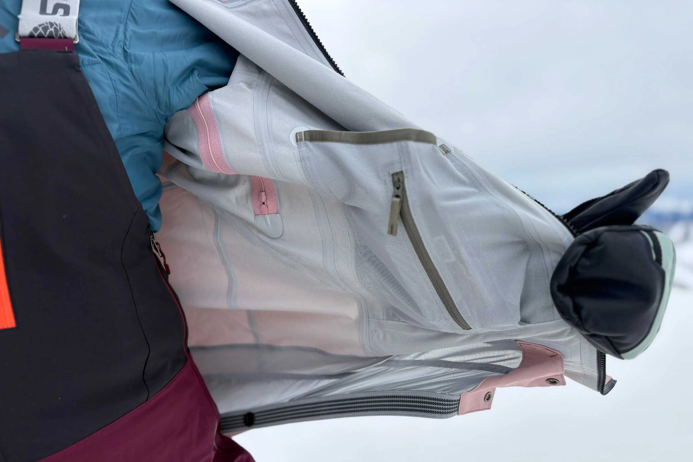 Close-up of snowboard-specific features like powder skirt and inside zipper pocket on the Arc’Teryx Sentinel