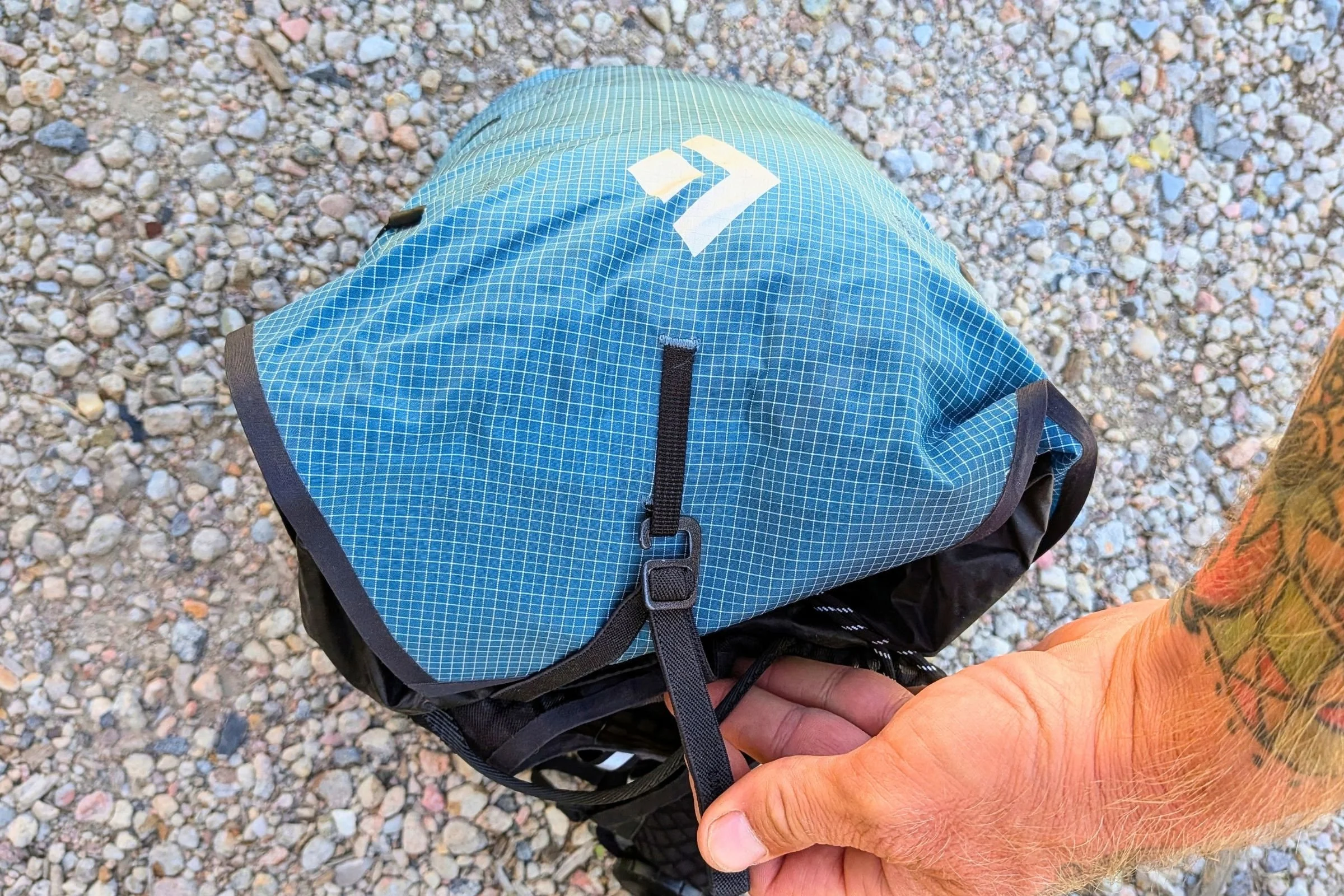 Close-up of the blue Black Diamond Distance 15 Backpack’s lower panel and attachment hardware