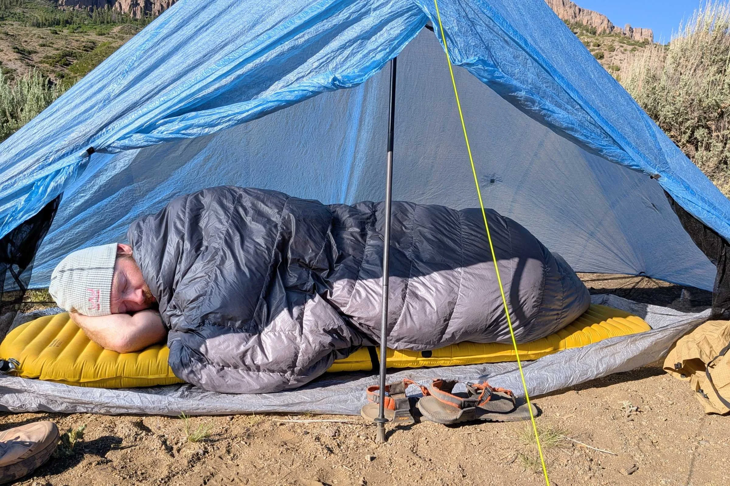 Outdoor Vitals StormLoft 15 Down TopQuilt — person sleeping in a tent