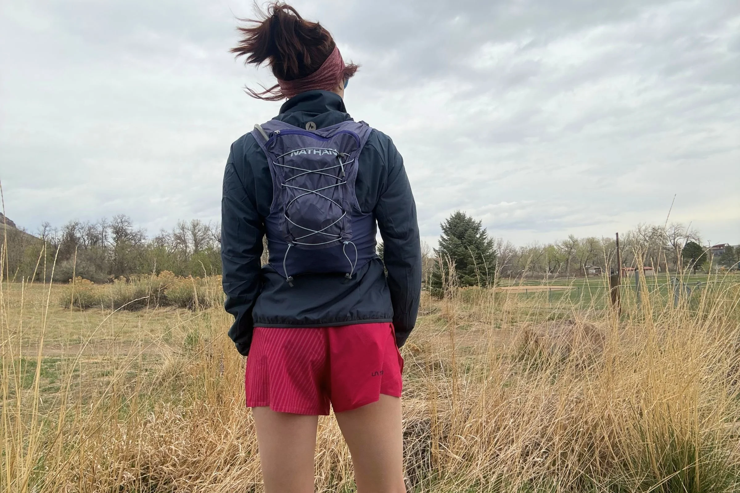 The Nathan VaporAir and VaporAiress have 8L of capacity, which is plenty for the 2L hydration bladder, layers, snacks, and whatever else you may want to carry on a trail run.