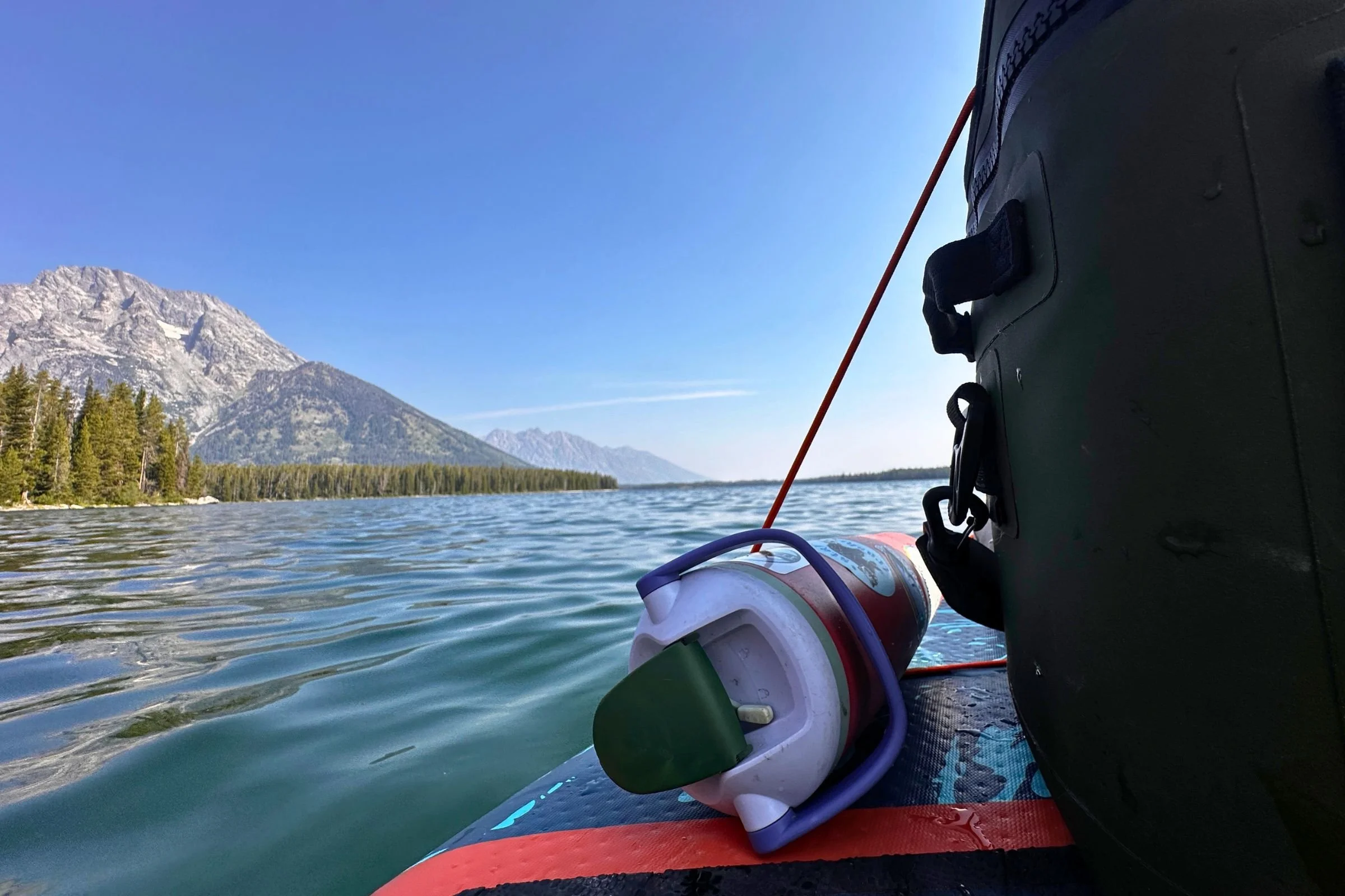 The Owala Free Sip Sway on its side on a paddleboard.