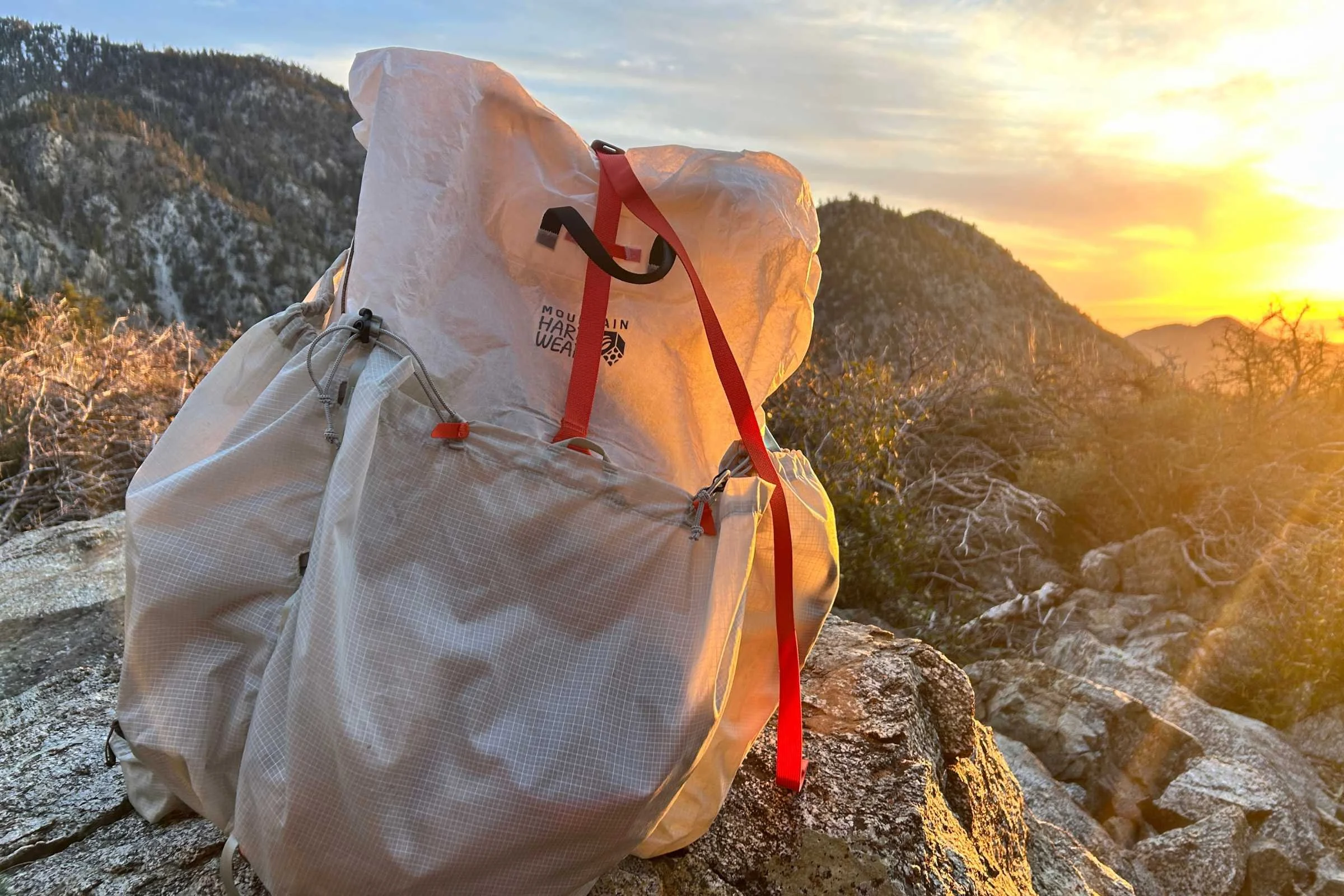 the mountain hardwear aluula alakazam backpack on a rock at sunset