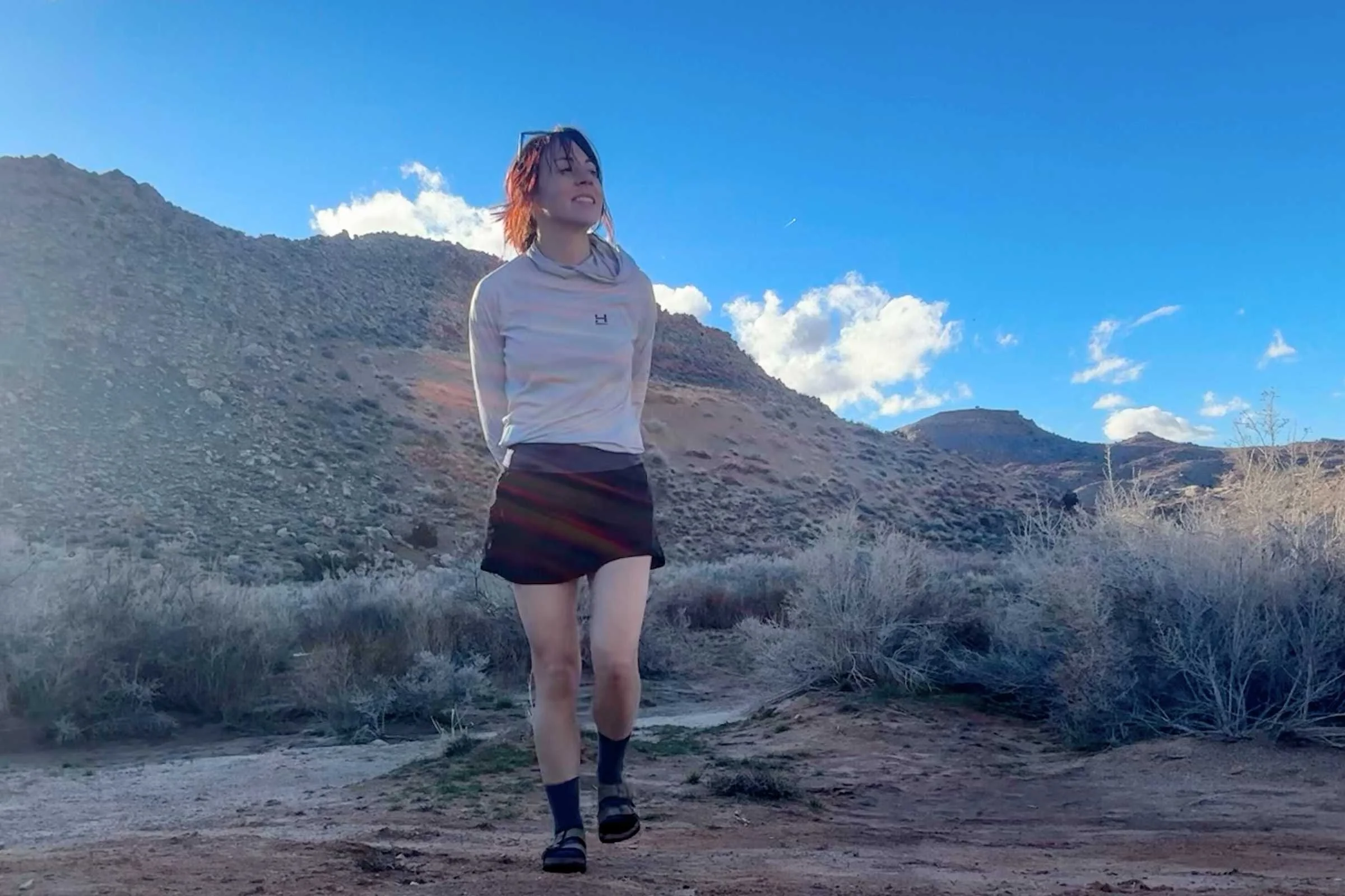 person walking on a desert trail in birkenstock arizona sandals