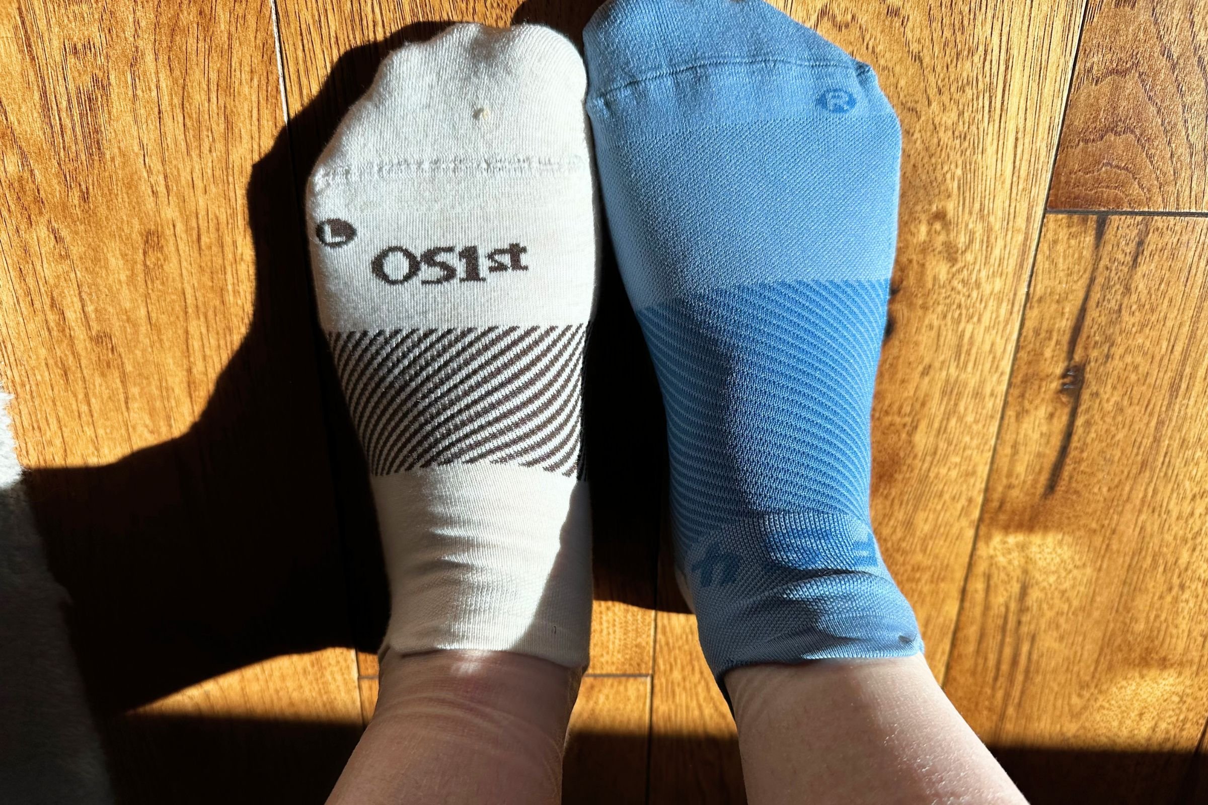 The white sock (left) is the OS1st Merino Wool Wicked Sock, the blue sock (right) is the OS1st Plantar Fasciitis Quarter Crew Sock.