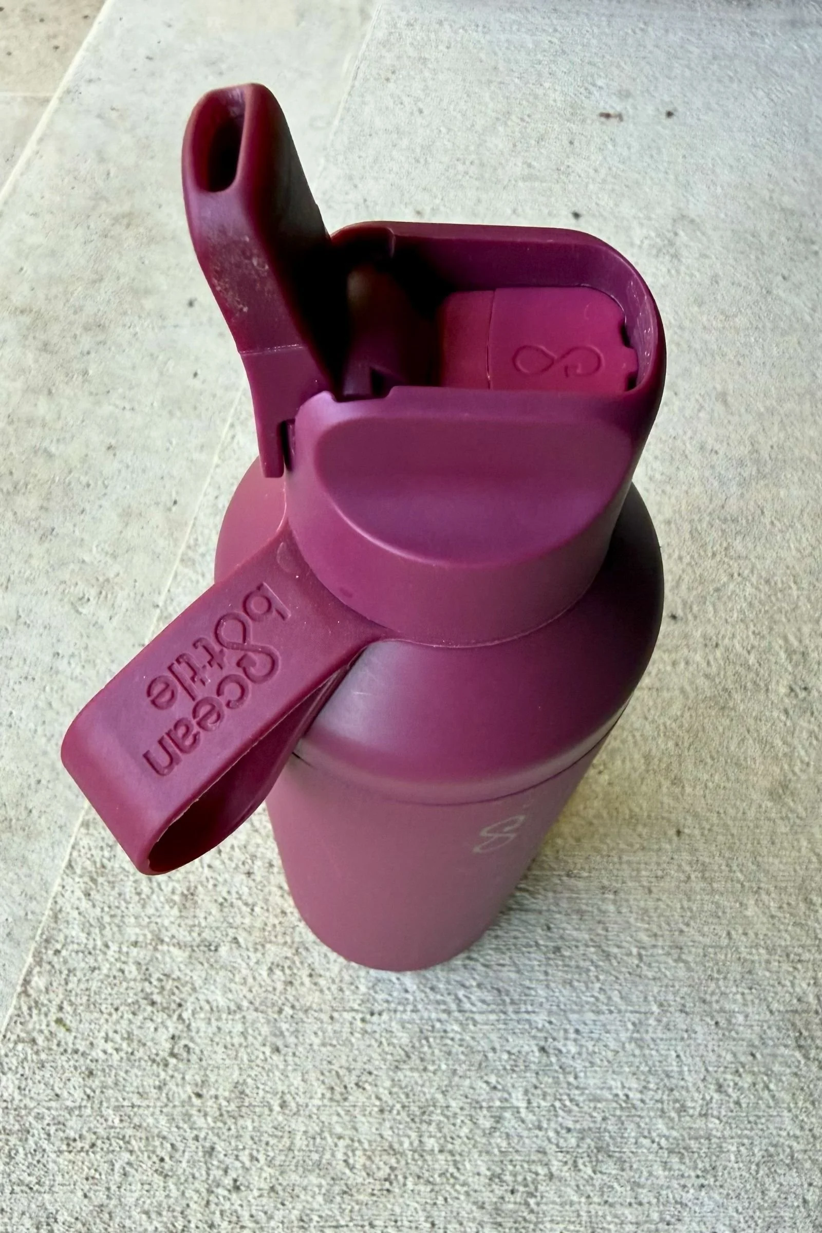 Close-up of the Ocean Bottle Peak Go sip-straw opening with a red lid.