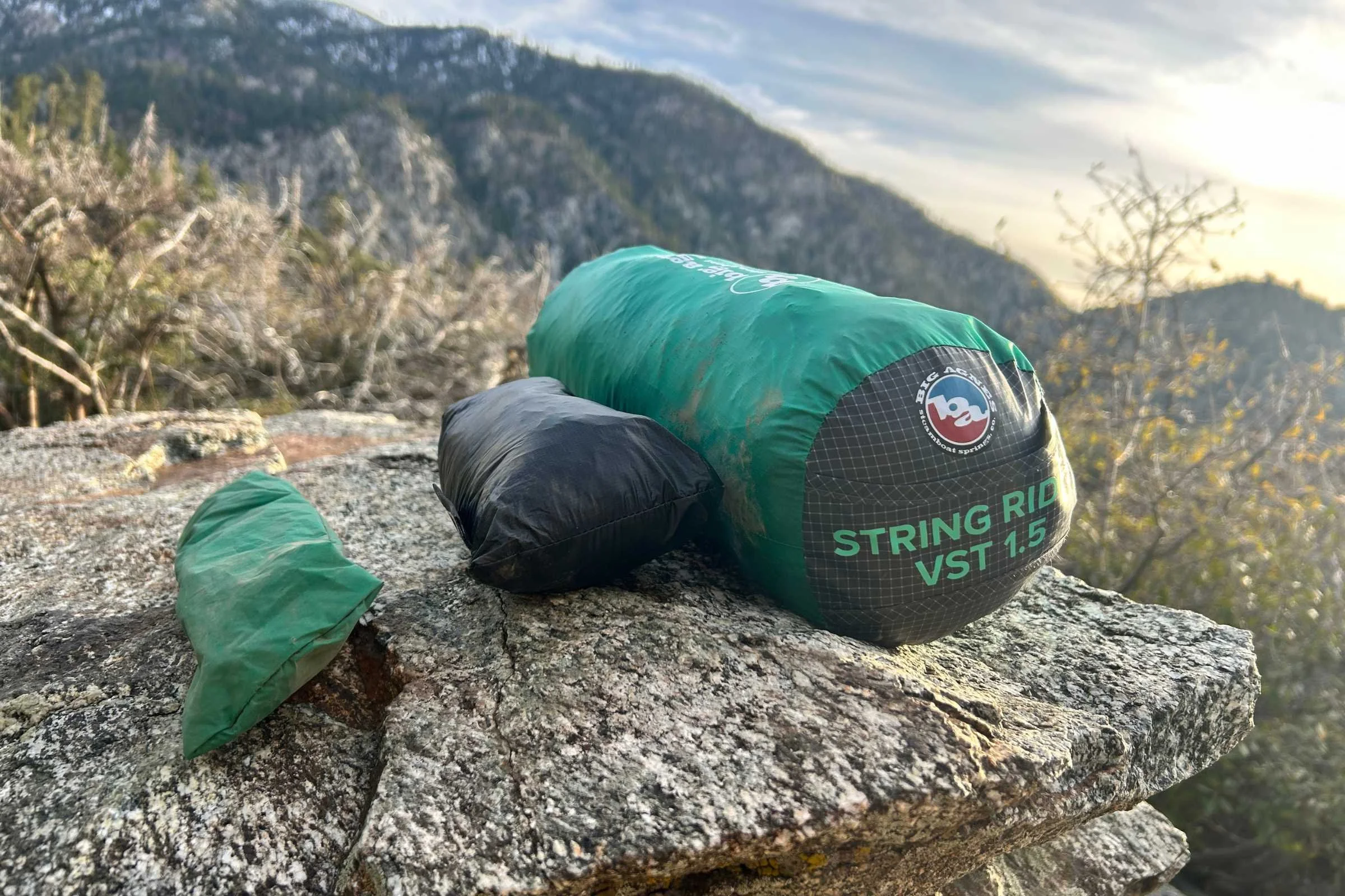 The Big Agnes String VST tent fully packed up with stake bag (far left) and footprint (middle).