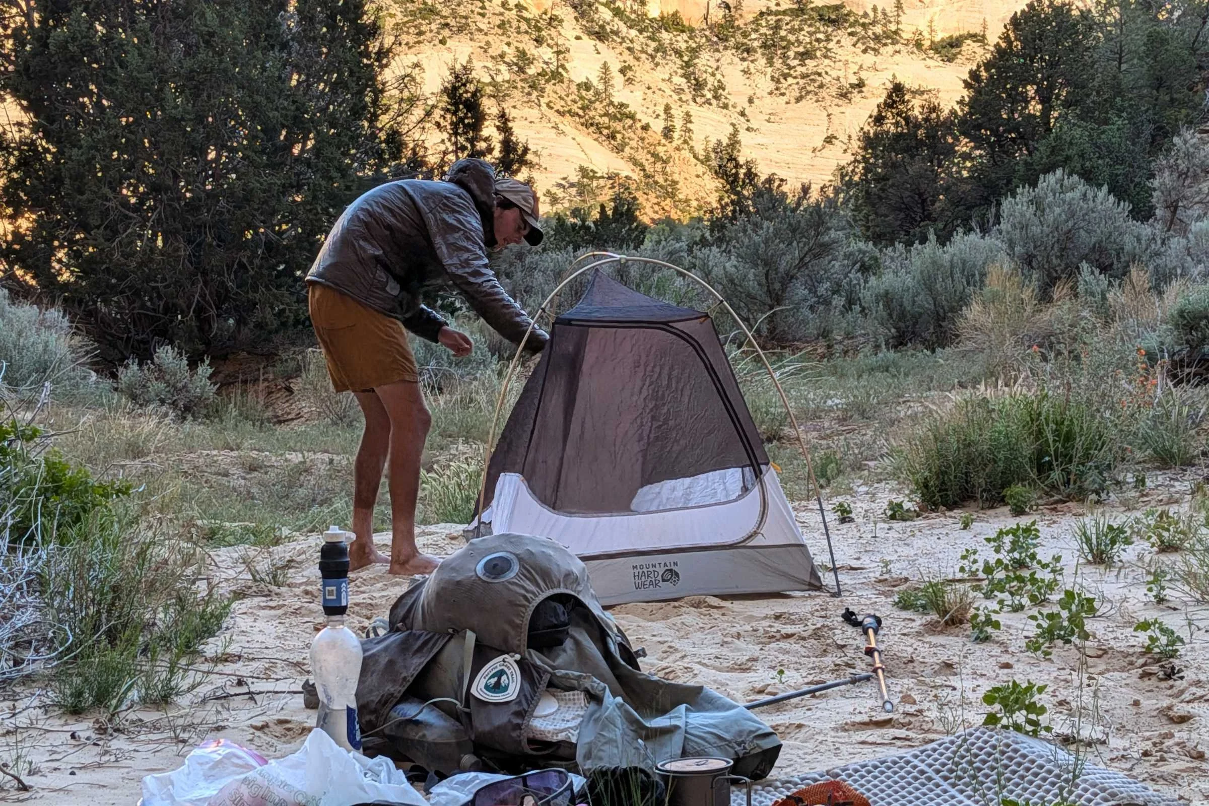 Backpacker in desert opening the Mountain Hardwear Nimbus UL tent