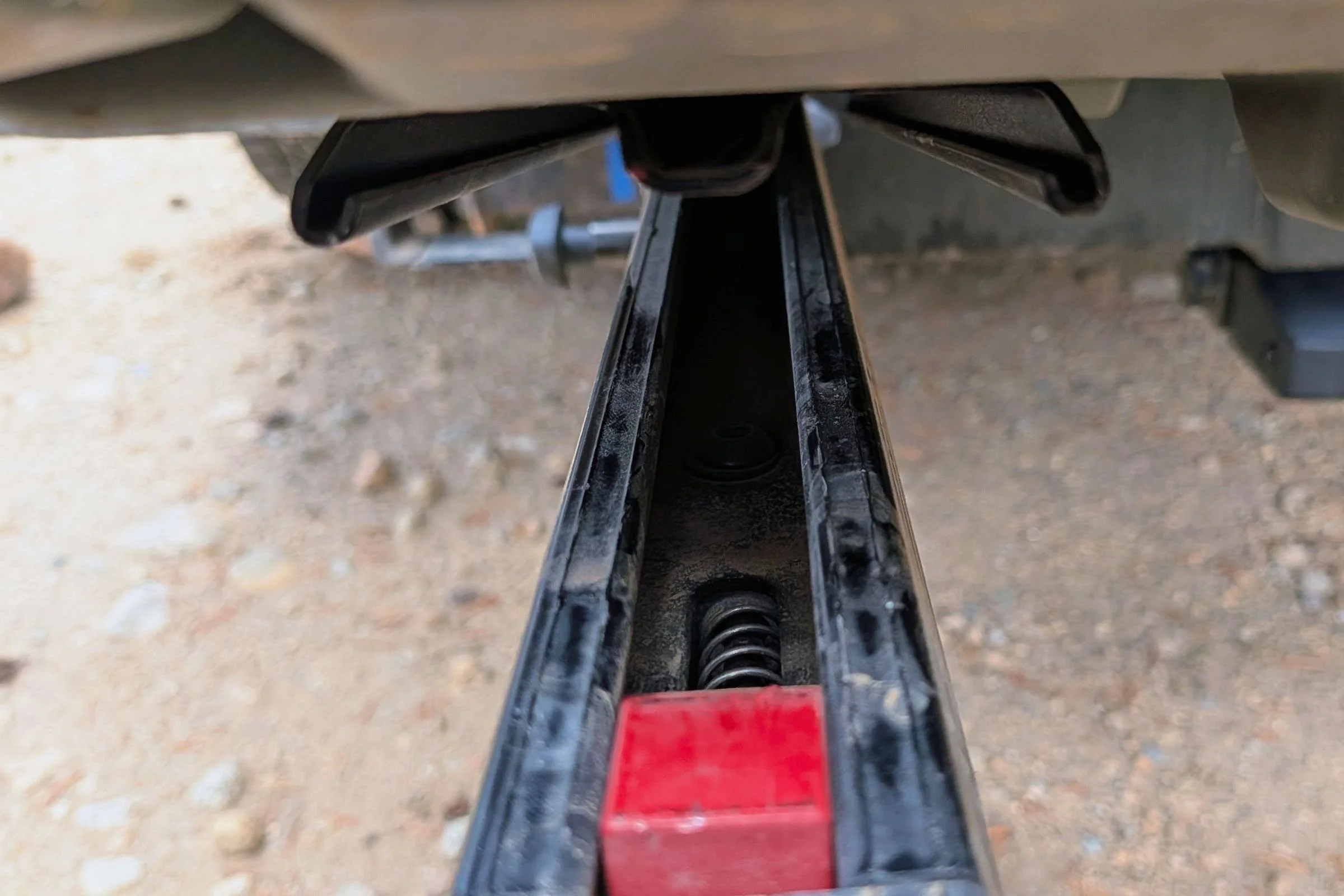 The front end of a truck with red and black accents and a Yakima EXO Swing visible at the rear.
