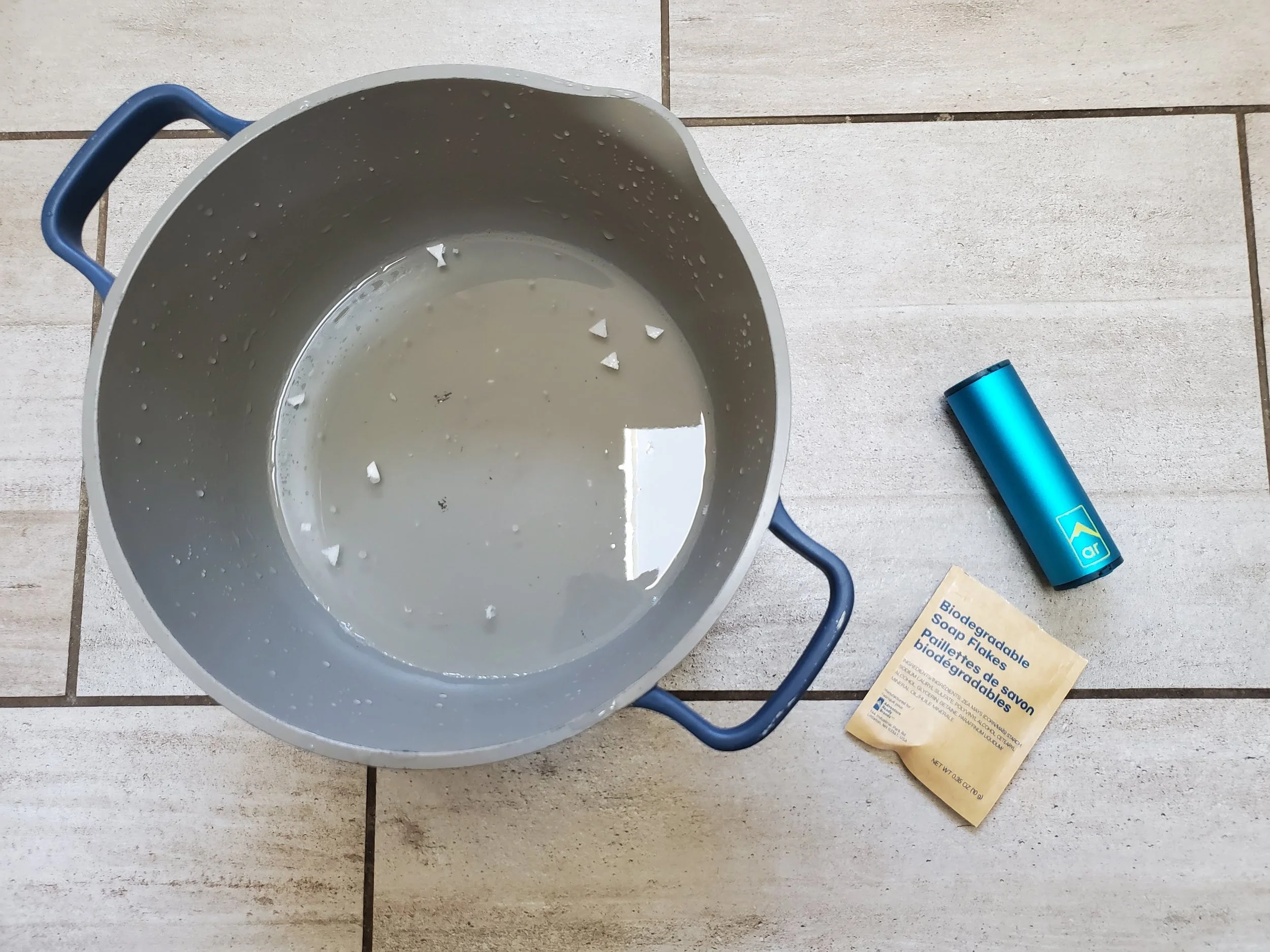 The Adventure Ready Clean Capsule soap flakes in a pot of water