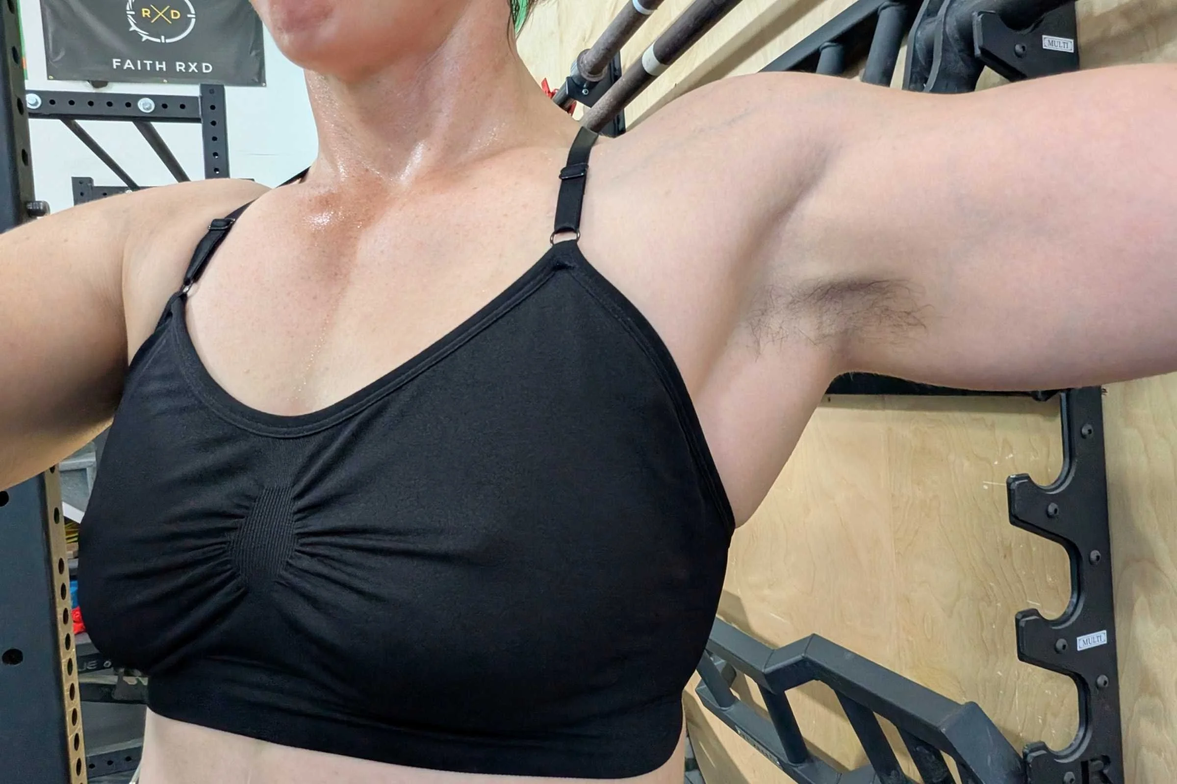 Tester wearing the Title Nine Wanna Sweat Racerback while working out at a Crossfit gym